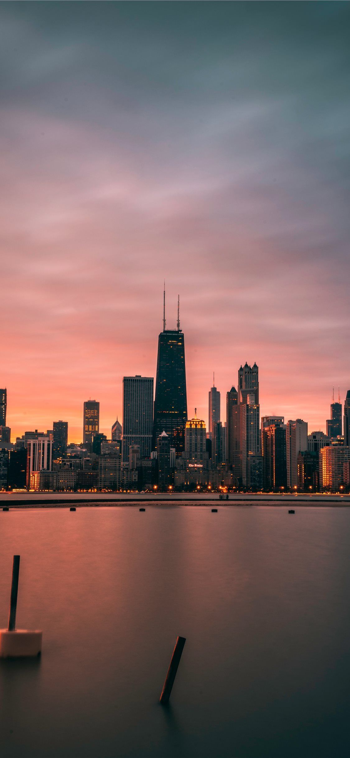 A city skyline at sunset with water in the foreground - Chicago