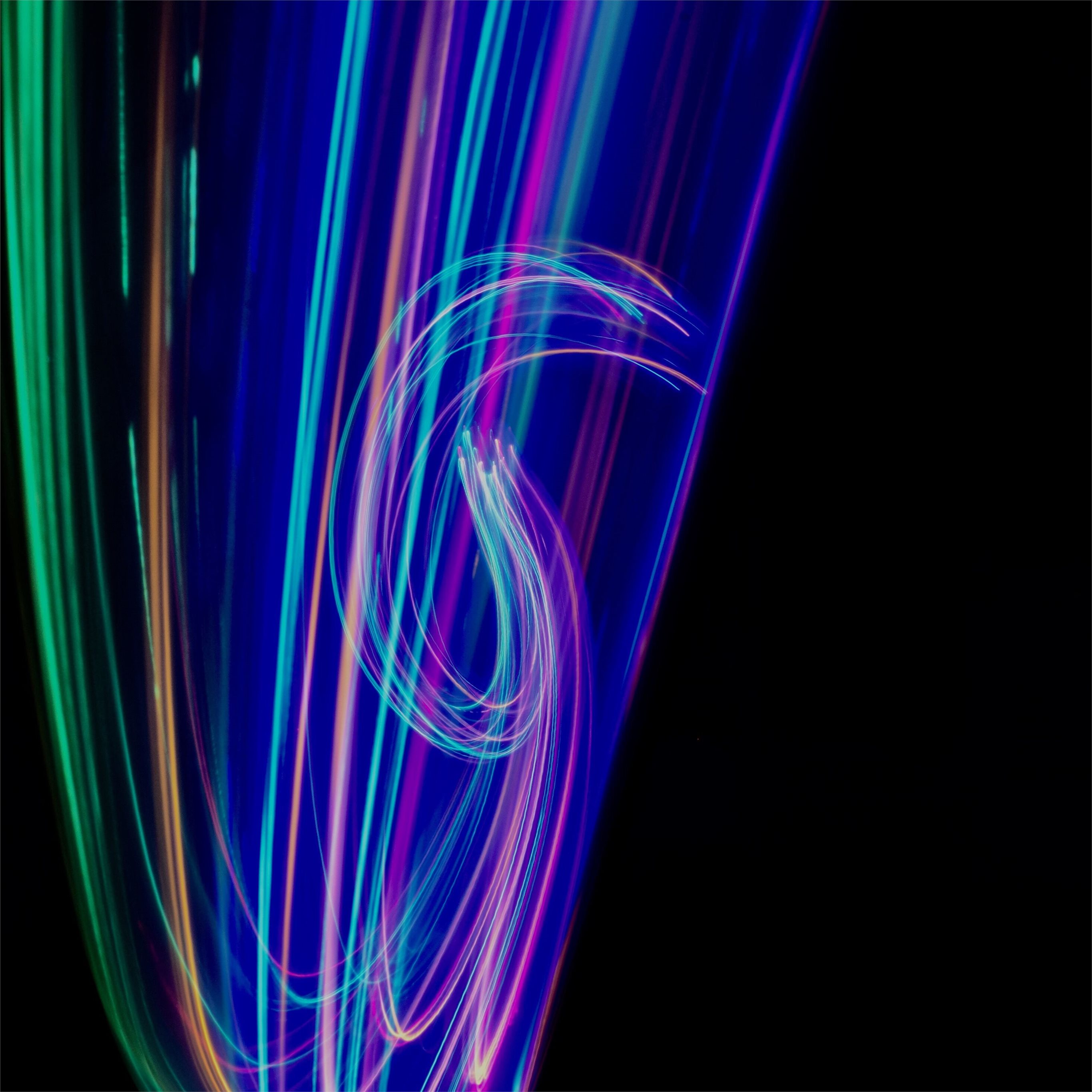 A photo of a multicolored light painting. - Neon blue