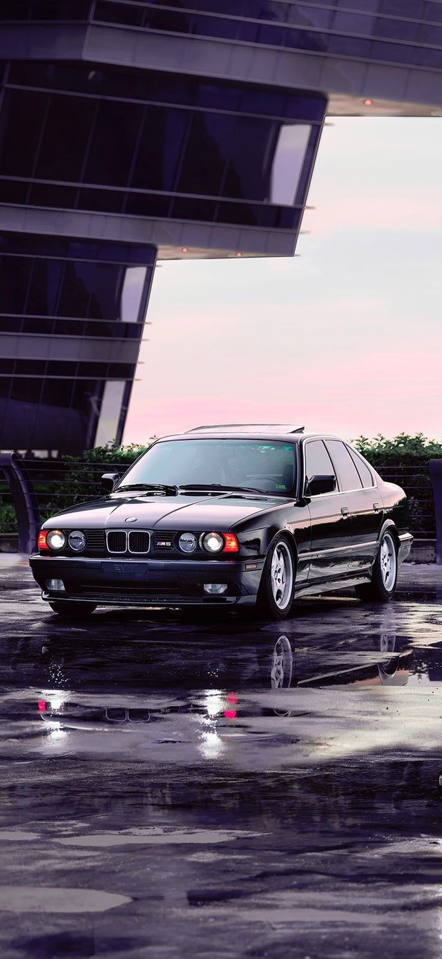 A black car parked in front of an office building - BMW