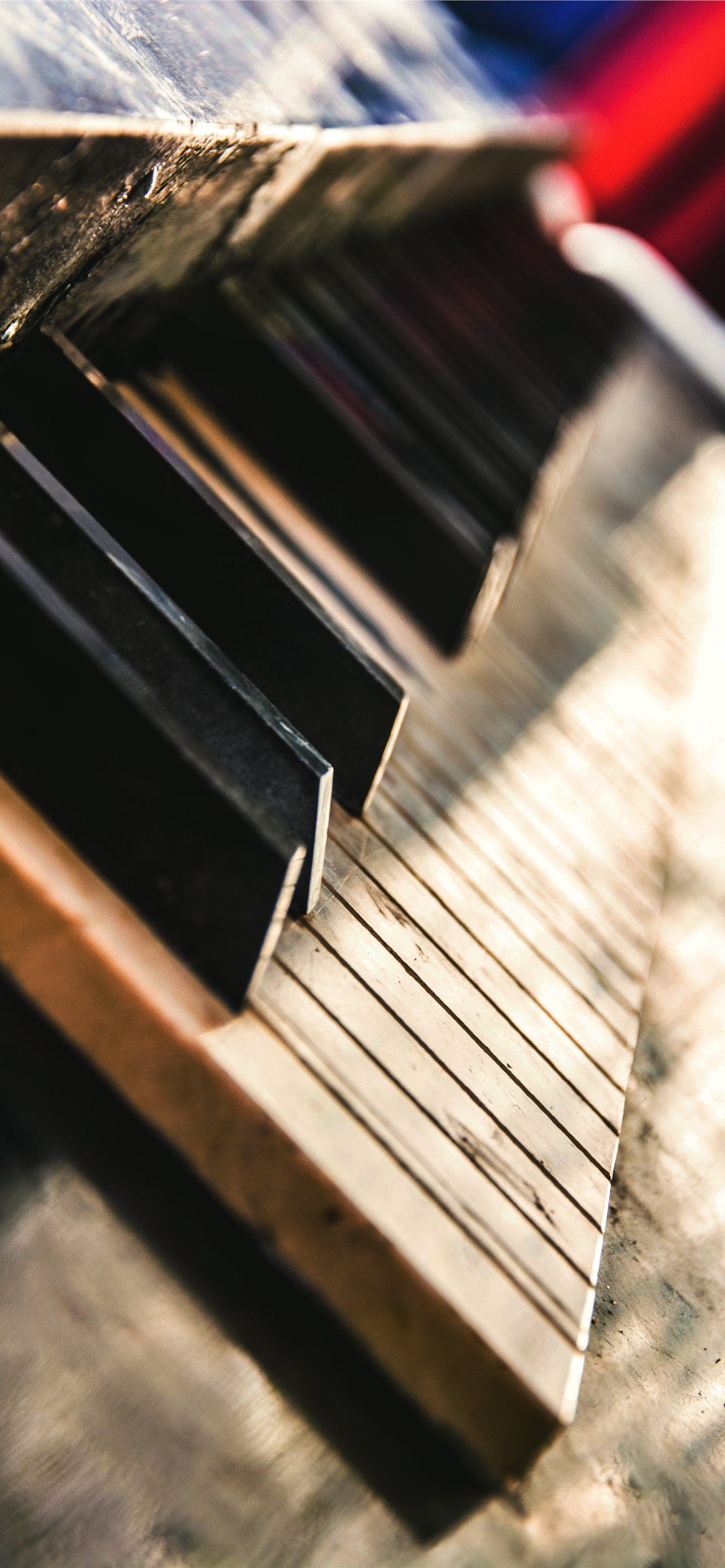 A close up of a bench with a book on it. - Piano