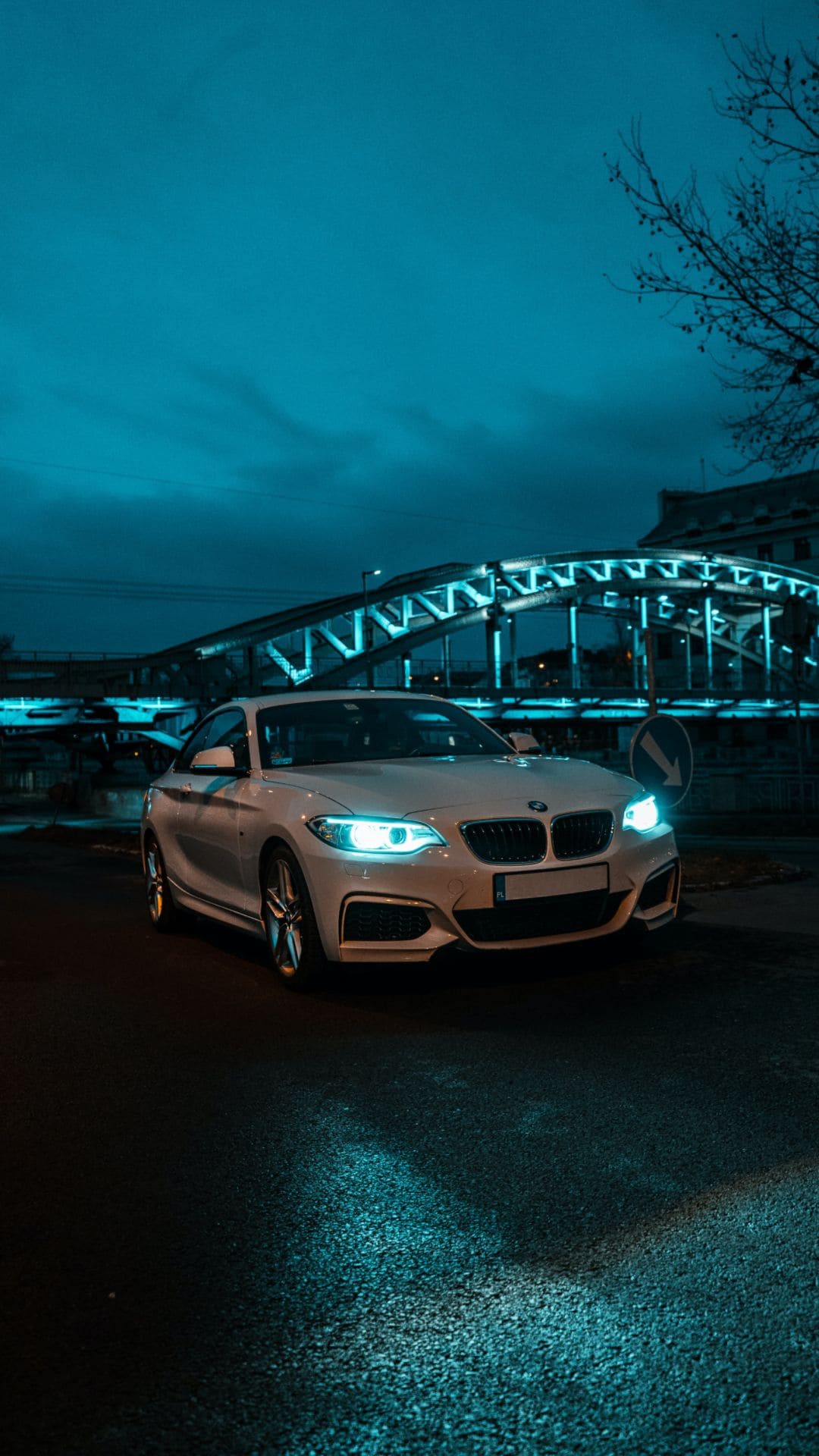 A car is parked in the middle of an empty street - BMW