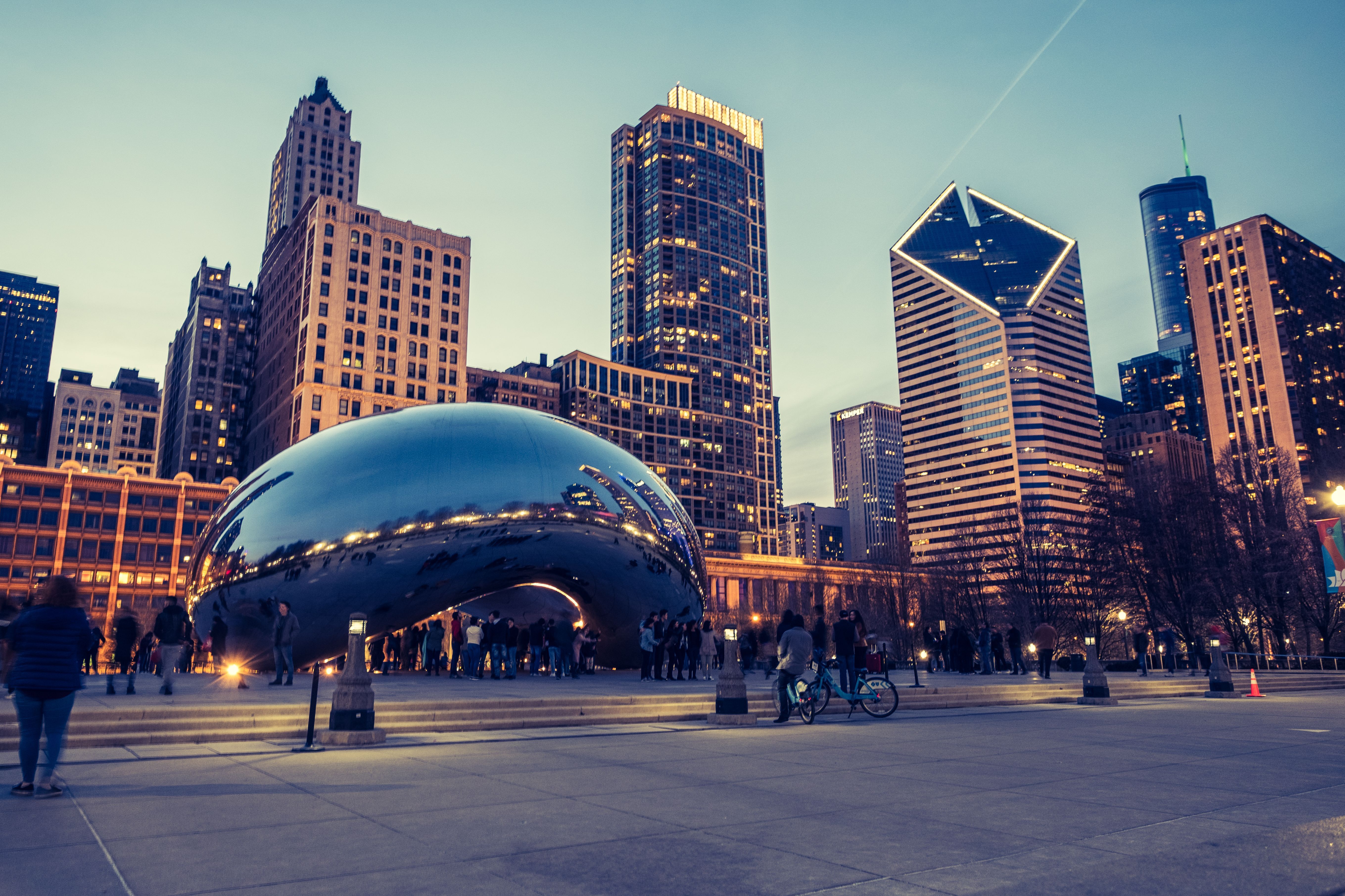 Cloud gate sculpture with the Chicago skyline in the background - Chicago