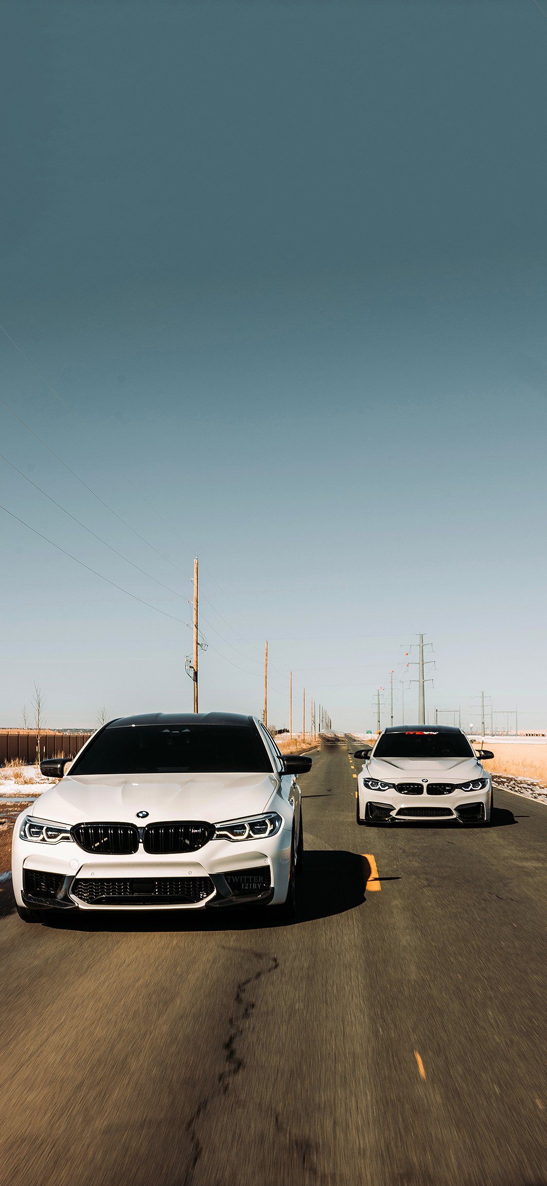 Two white BMW cars on the road. - BMW
