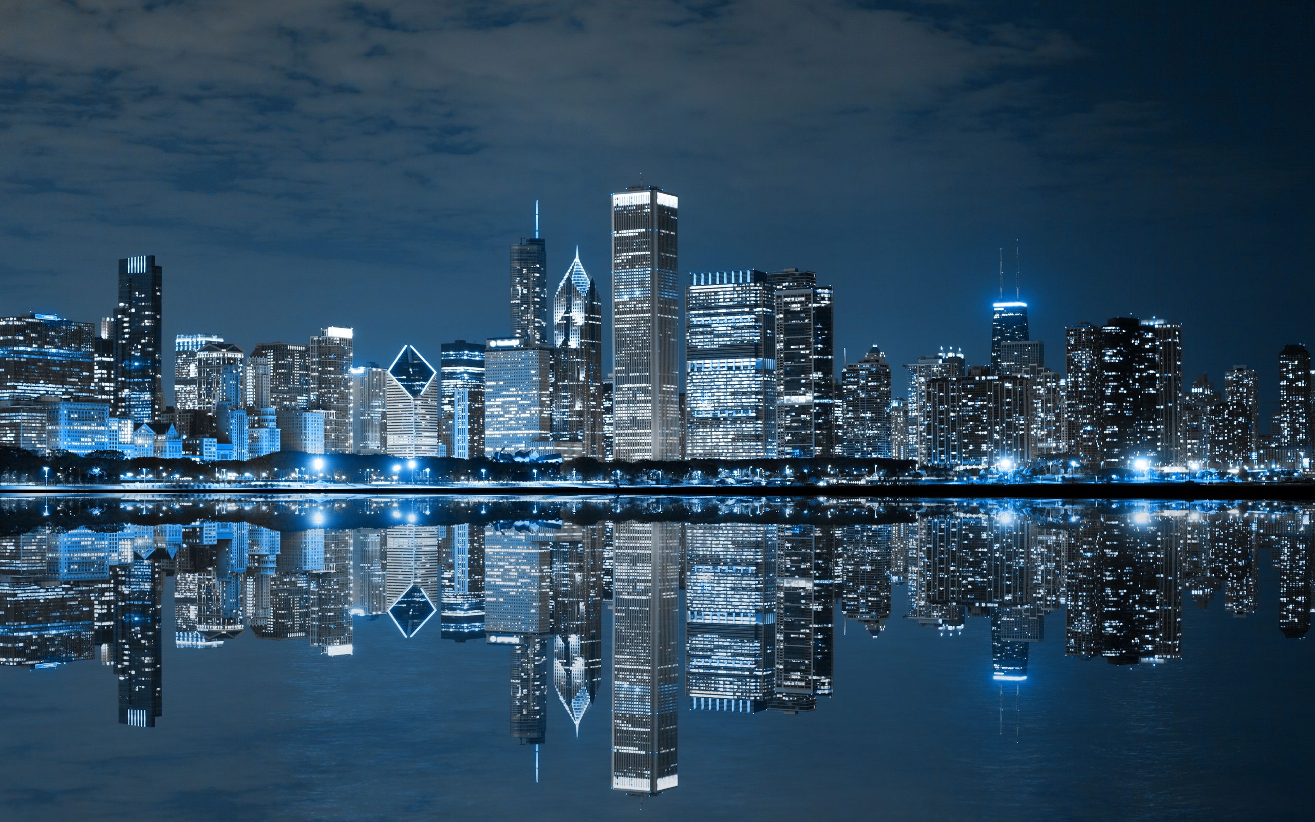 A city skyline at night with reflections in the water - Chicago