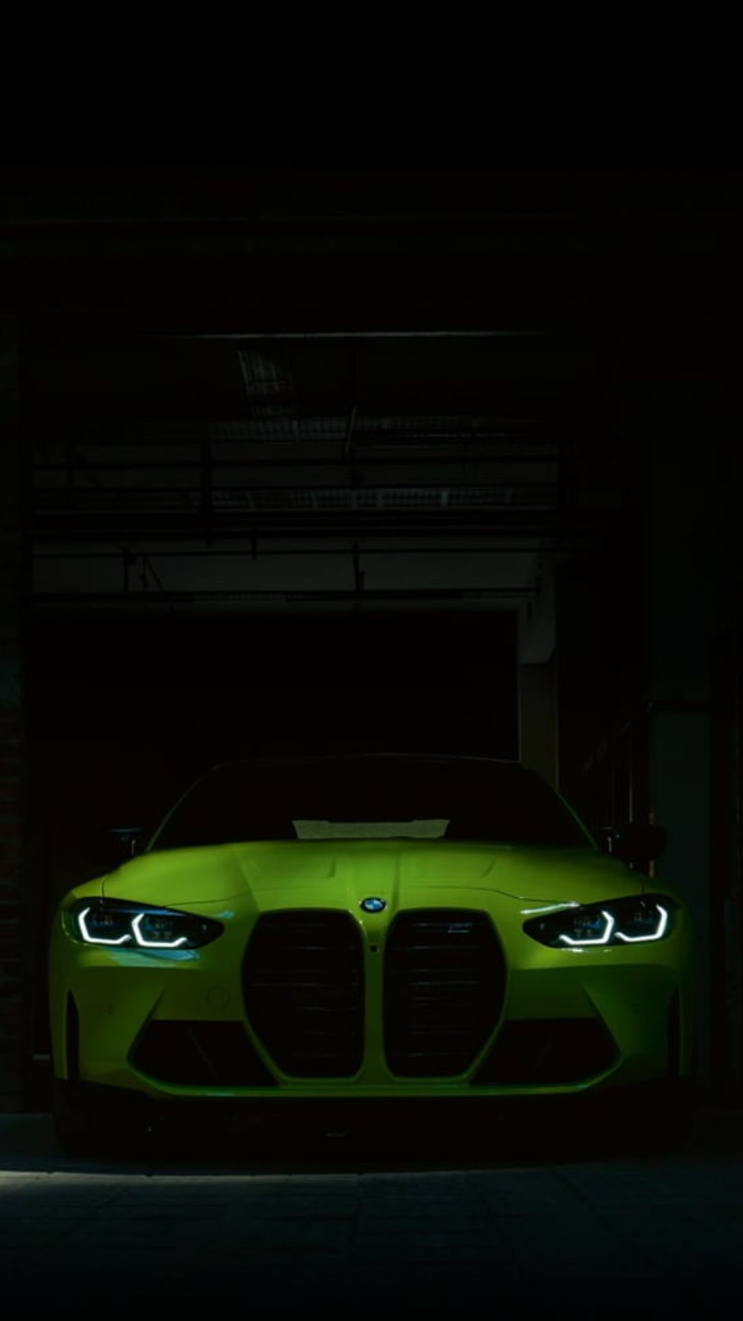 IPhone wallpaper of a green BMW sports car in a dark garage - BMW