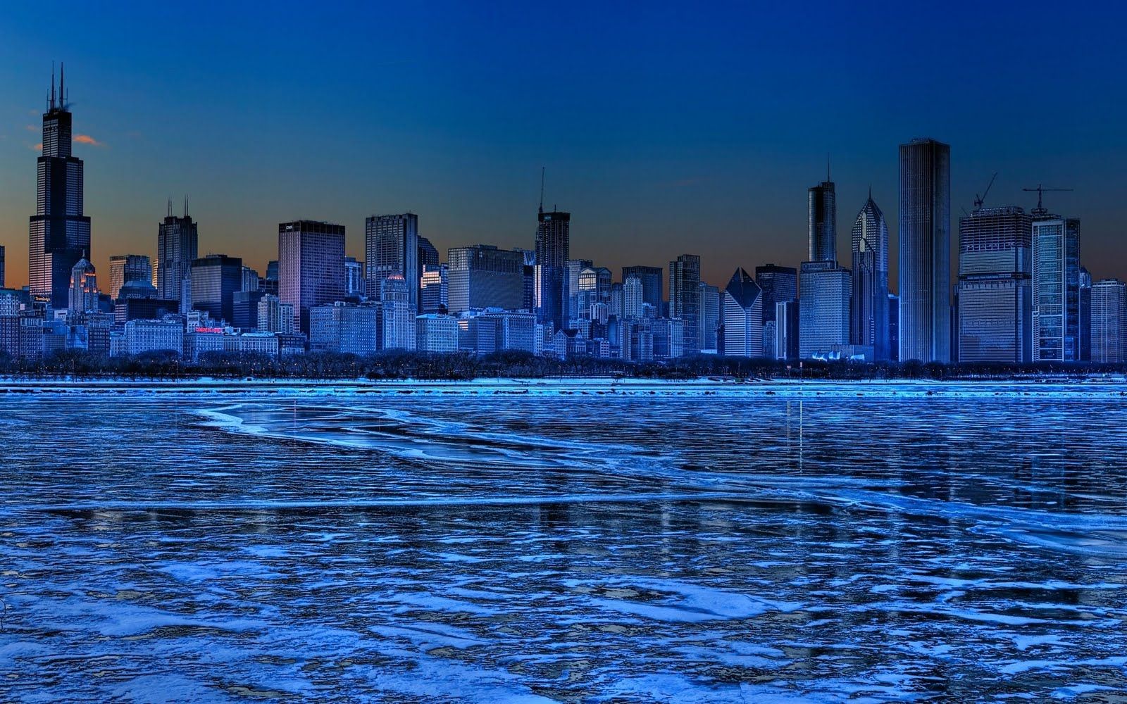 A city skyline is seen from across the water - Chicago