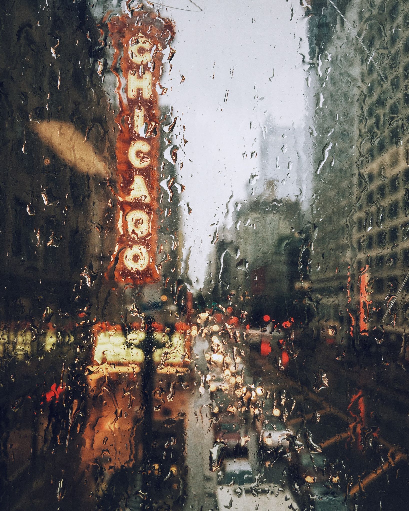 A rain covered city street with traffic - Chicago