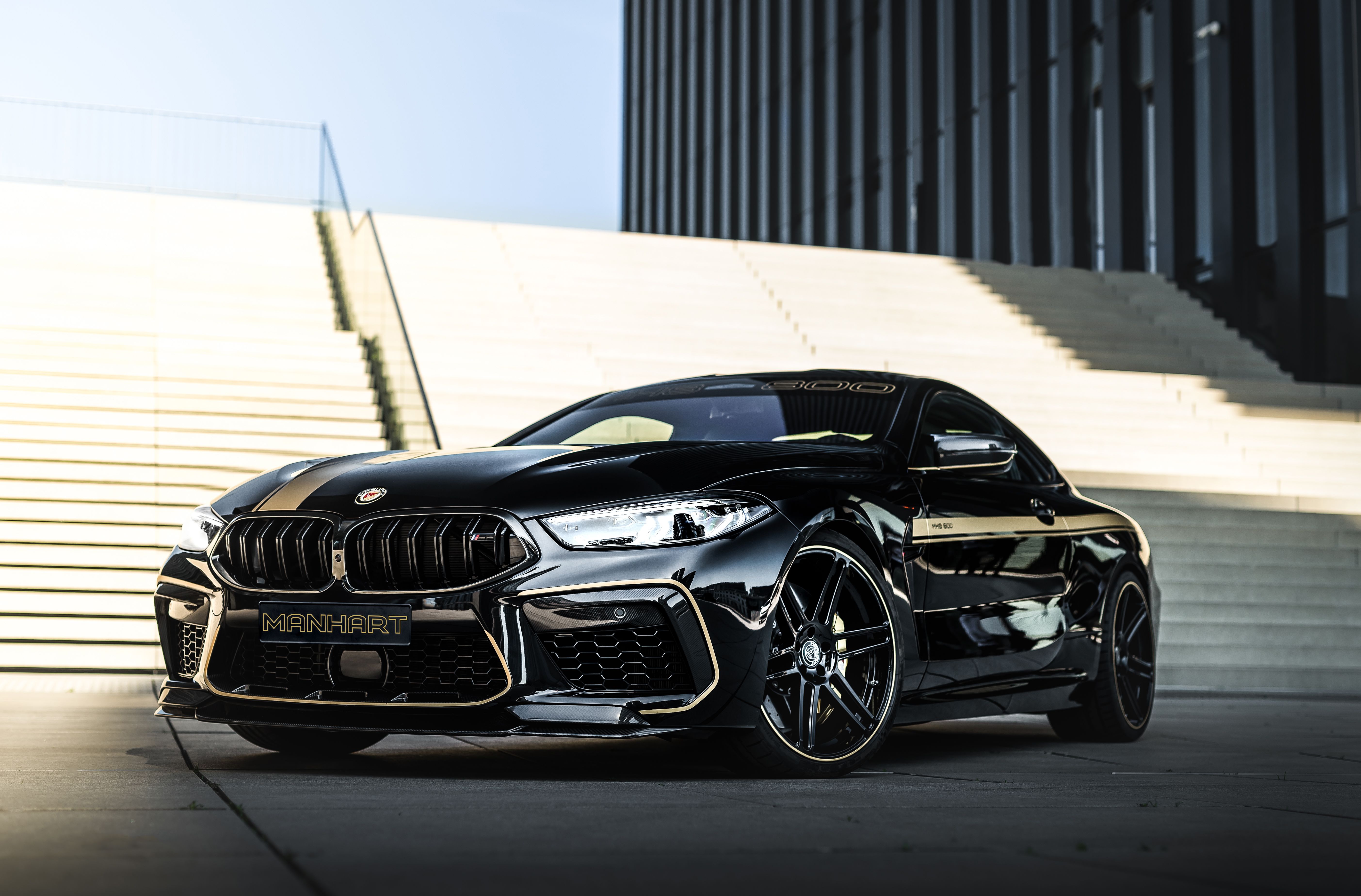 A black bmw sports car parked in front of stairs - BMW