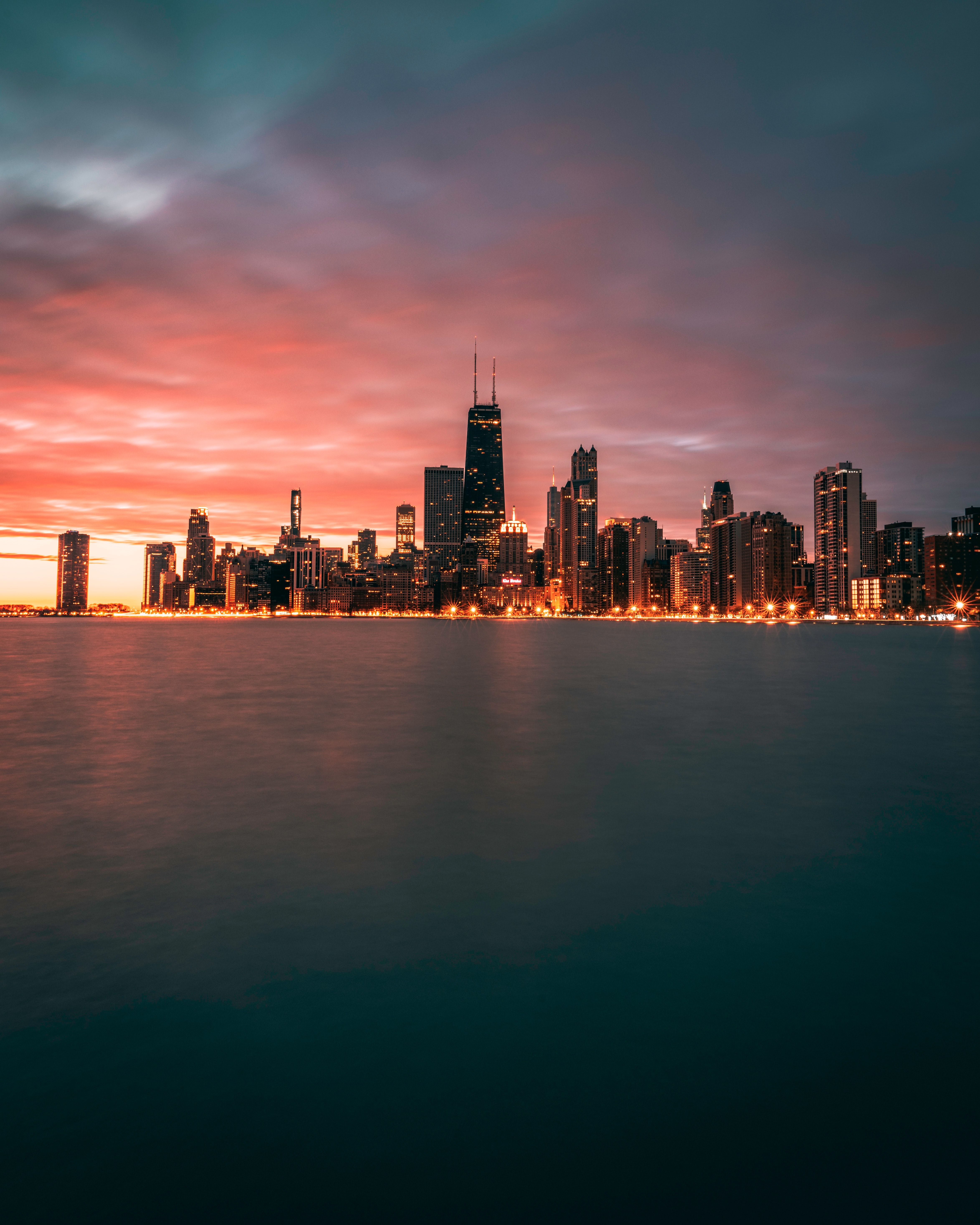 A city skyline at sunset with the water in front of it - Chicago