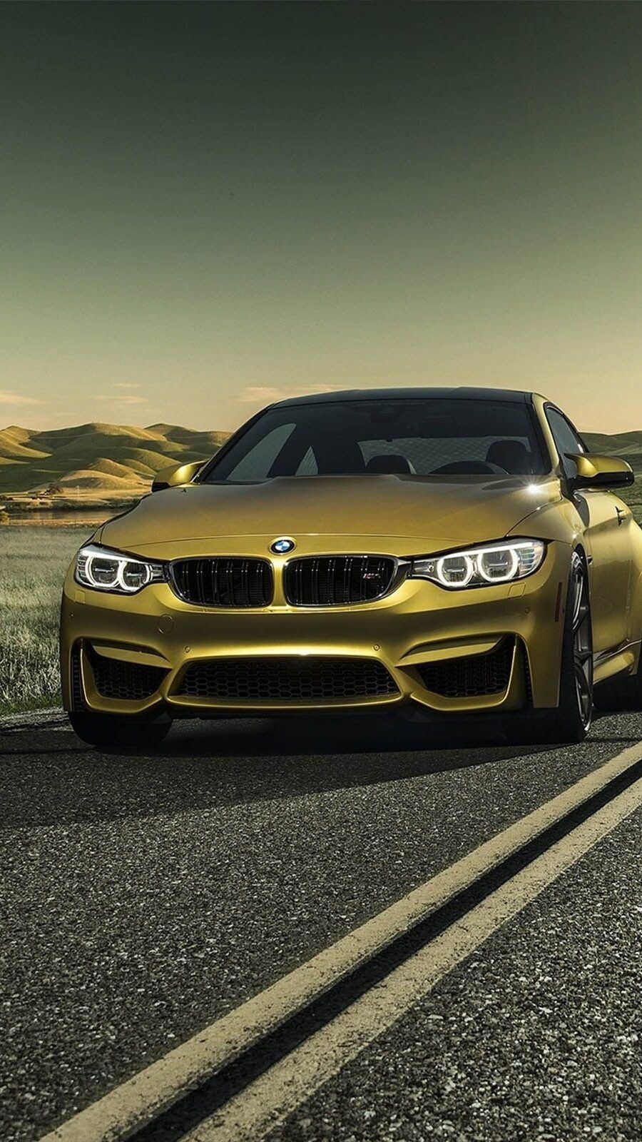 A gold BMW M4 on a desert road - BMW