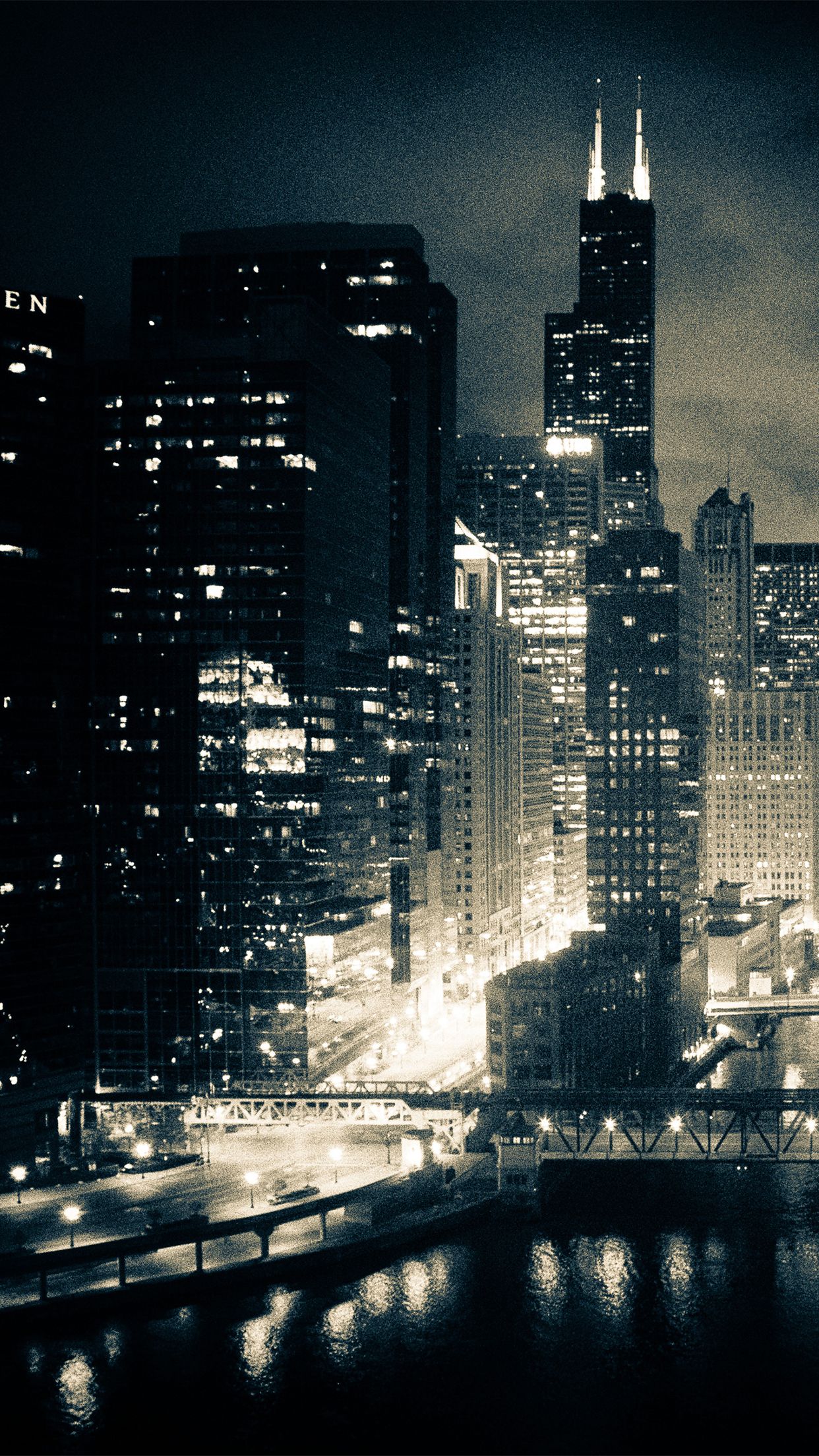 A city skyline at night with lights on - Chicago