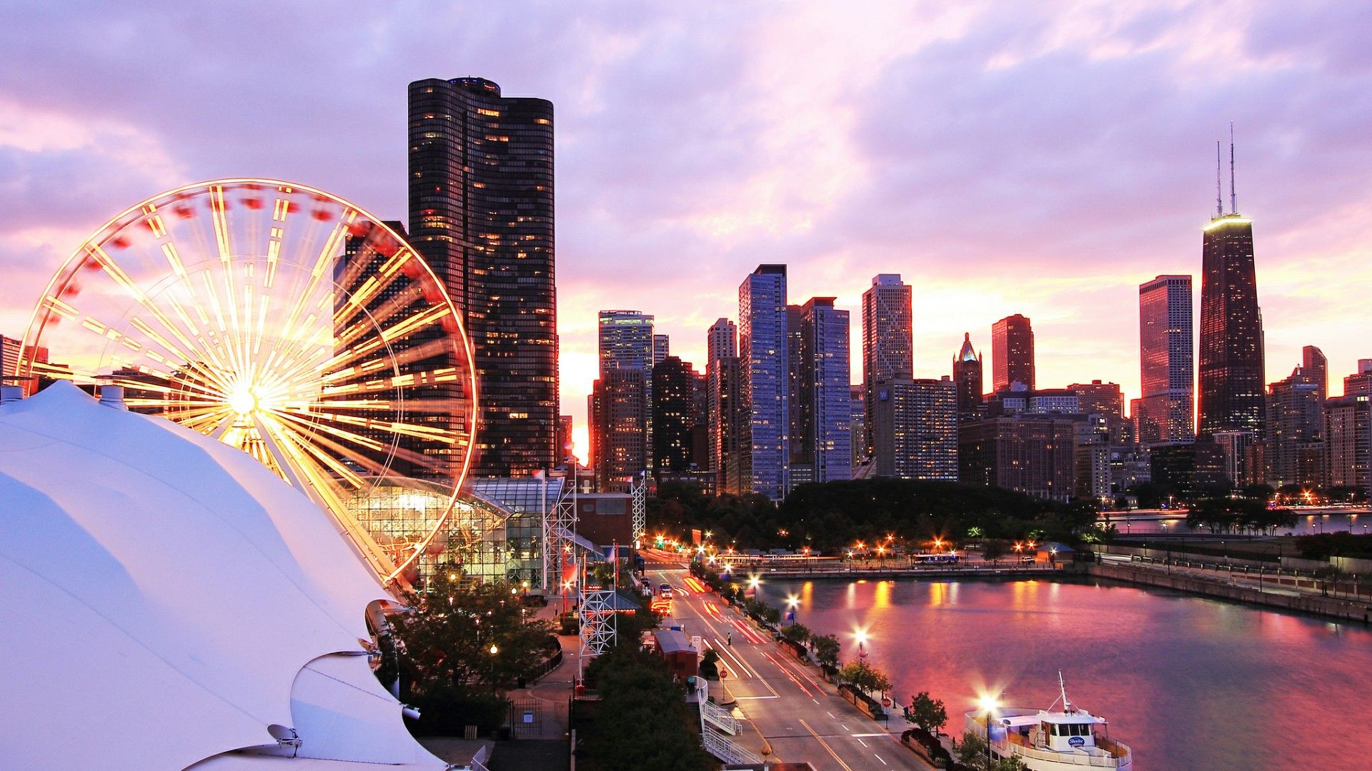 A ferris wheel and city skyline at sunset - Chicago