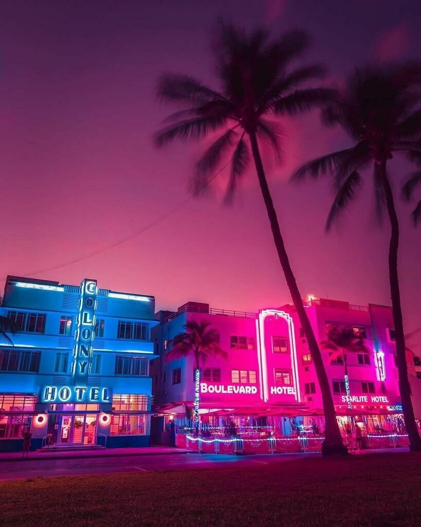 A neon lit building in miami at night - Miami, Florida