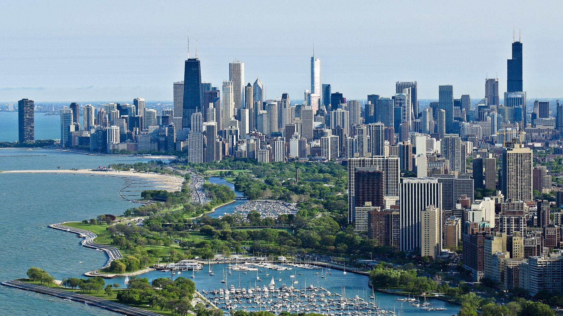 A bird's eye view of the Chicago skyline with Lake Michigan in the foreground. - Chicago