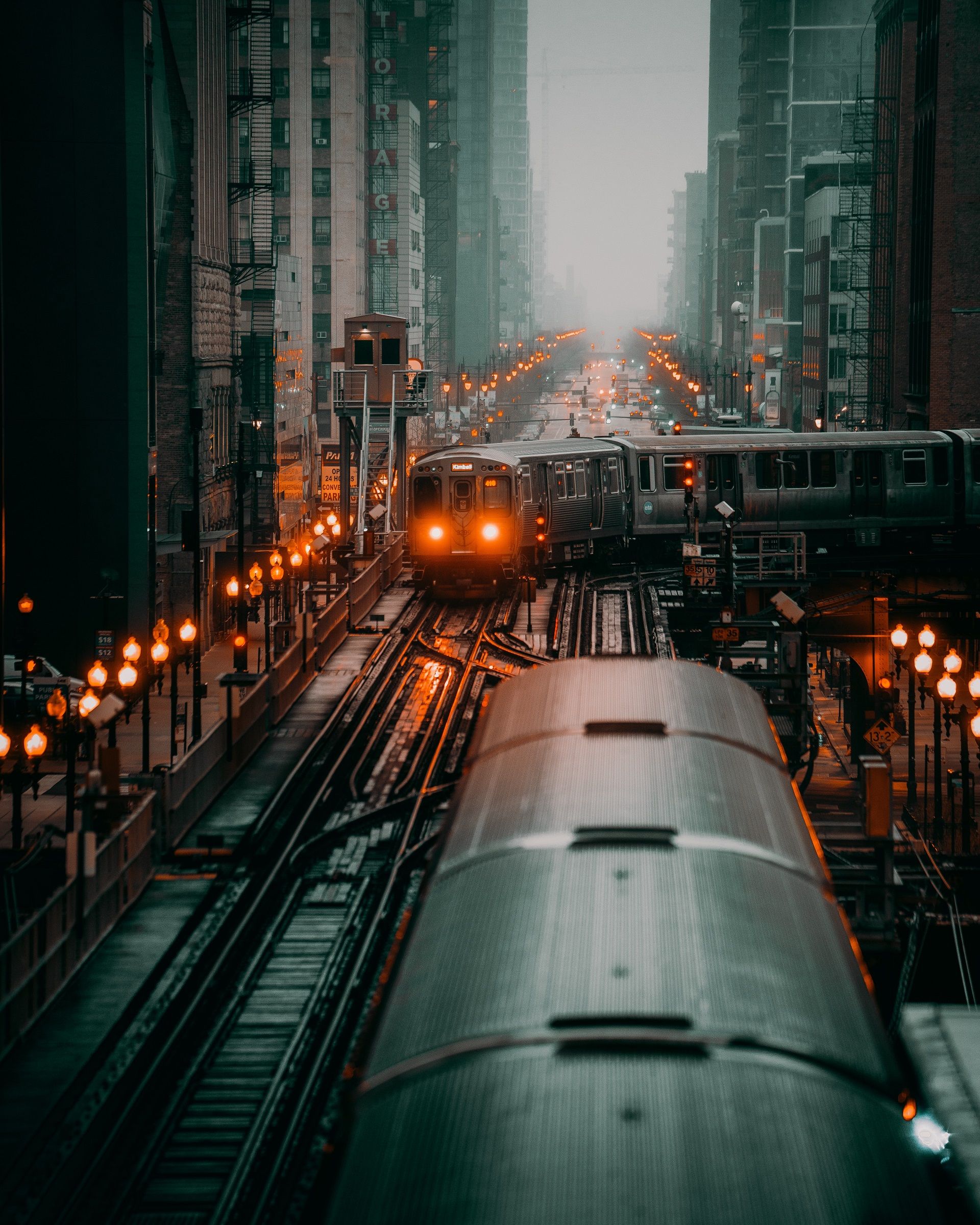 A train is traveling through the city at night. - Chicago