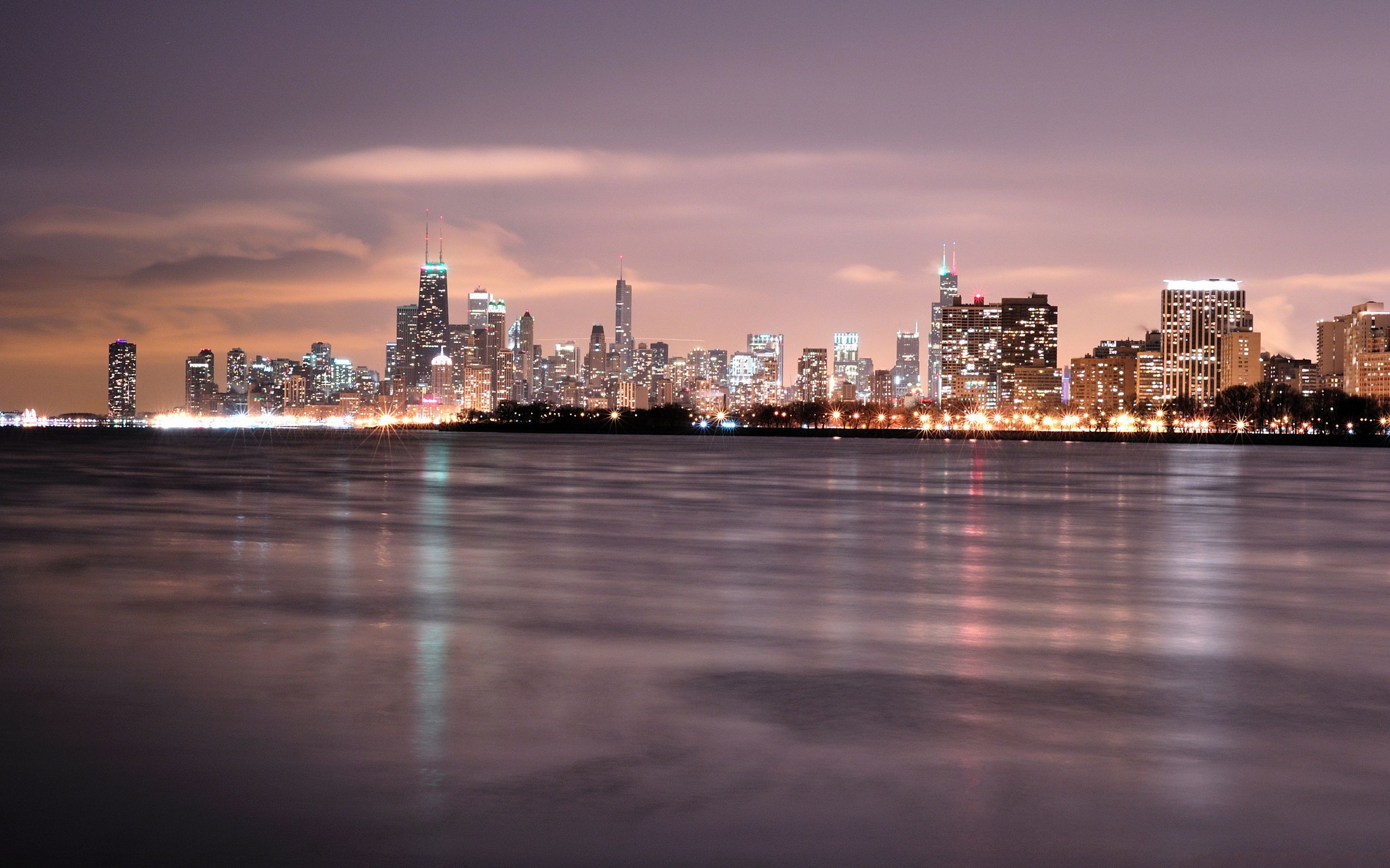 A city skyline at night over water - Chicago