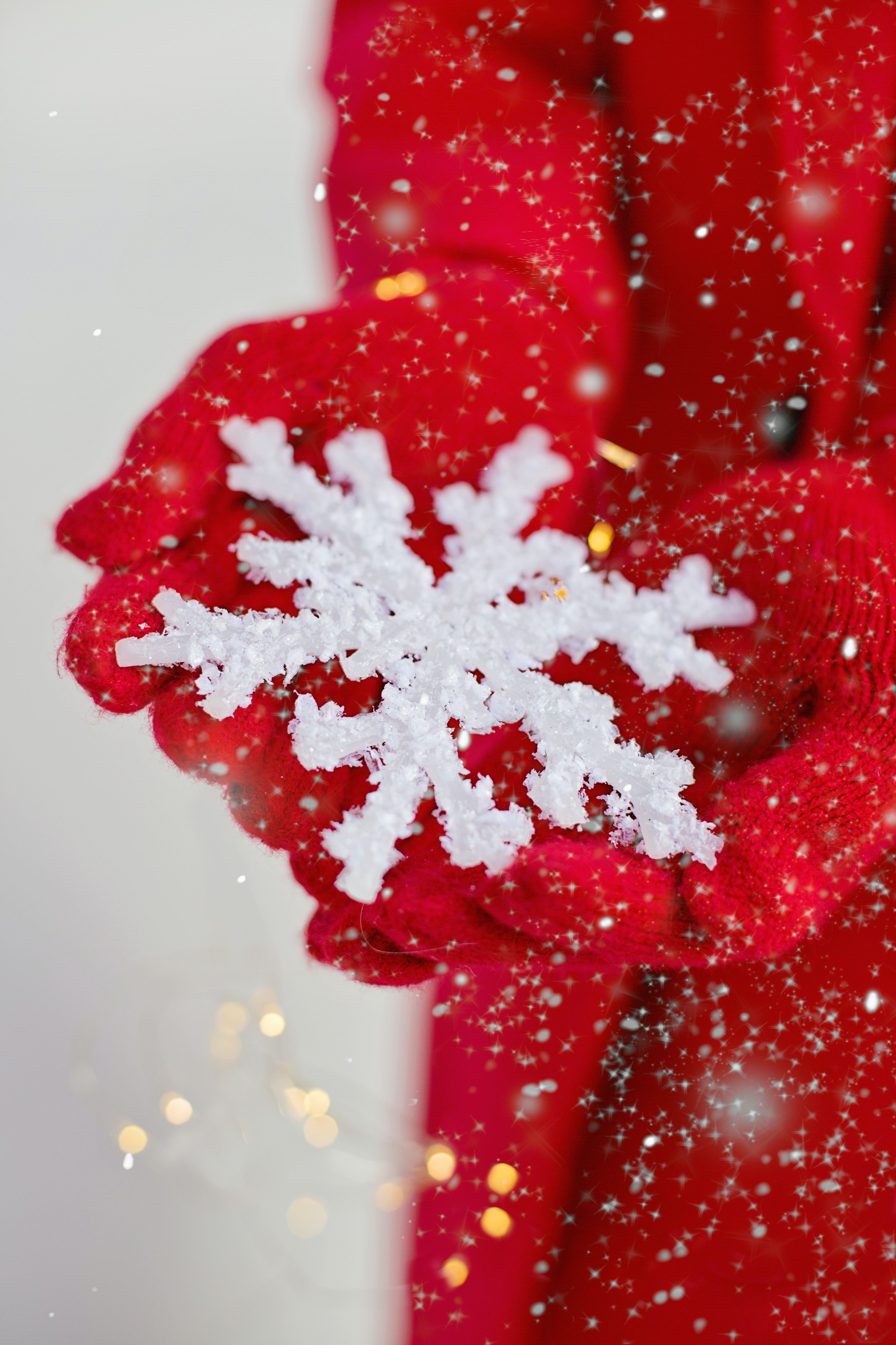 A woman's hands in red gloves holding a large snowflake - Snowflake, cute Christmas