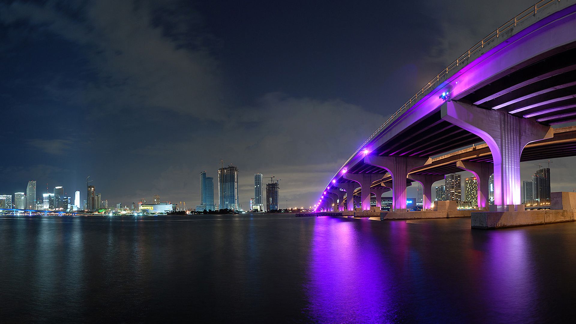 A bridge over water at night with lights - Miami