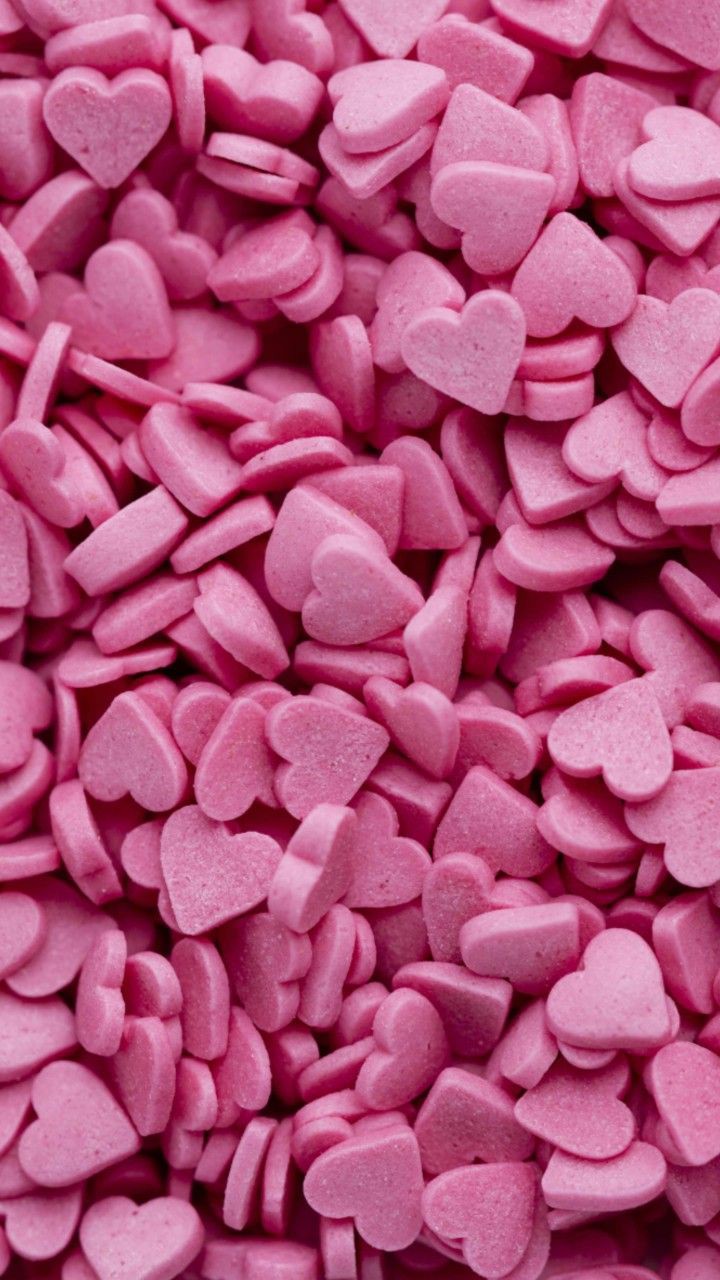 A close up of pink heart shaped candies - Pink heart