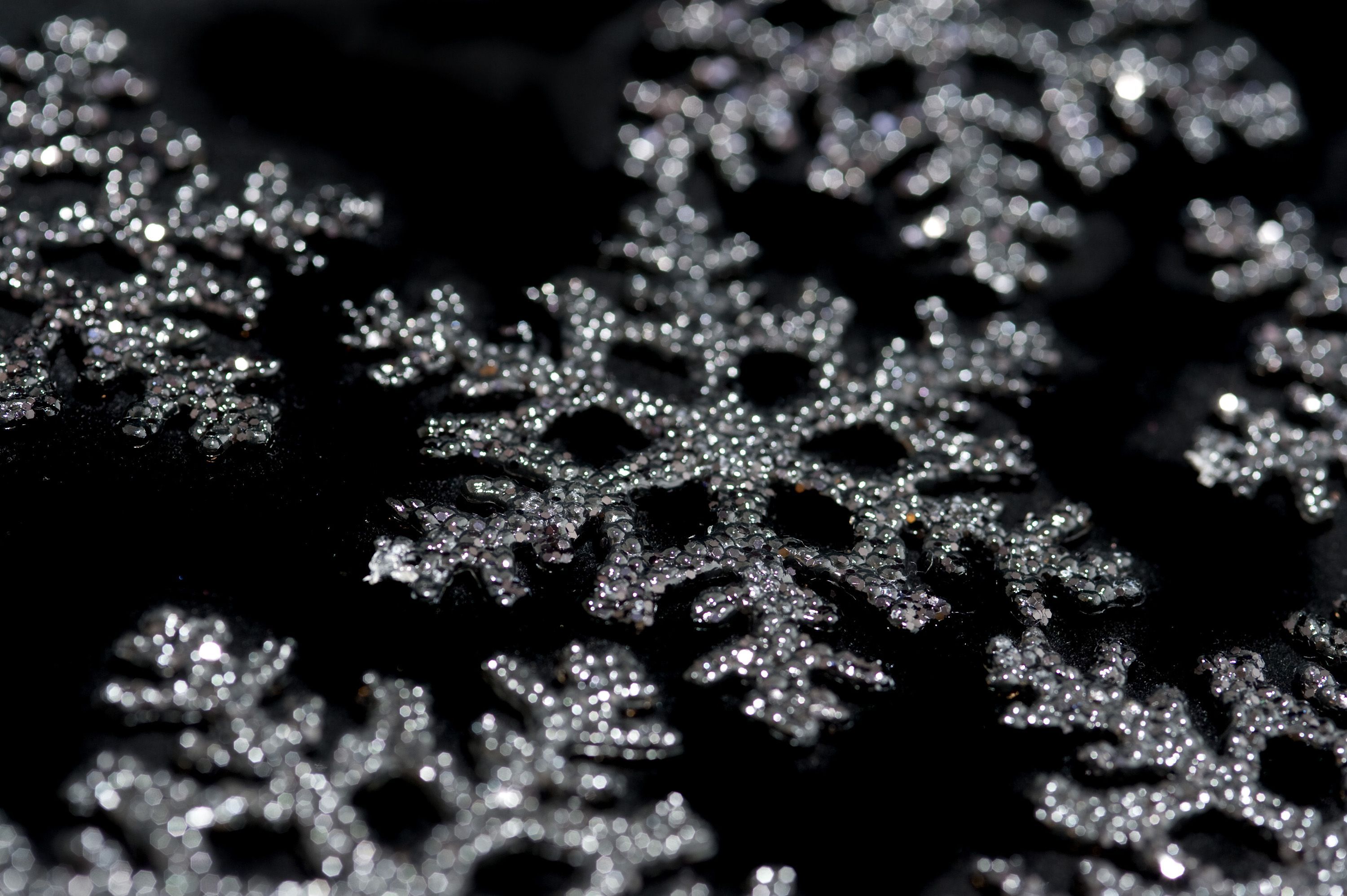 A close up of some silver snowflakes - Snowflake