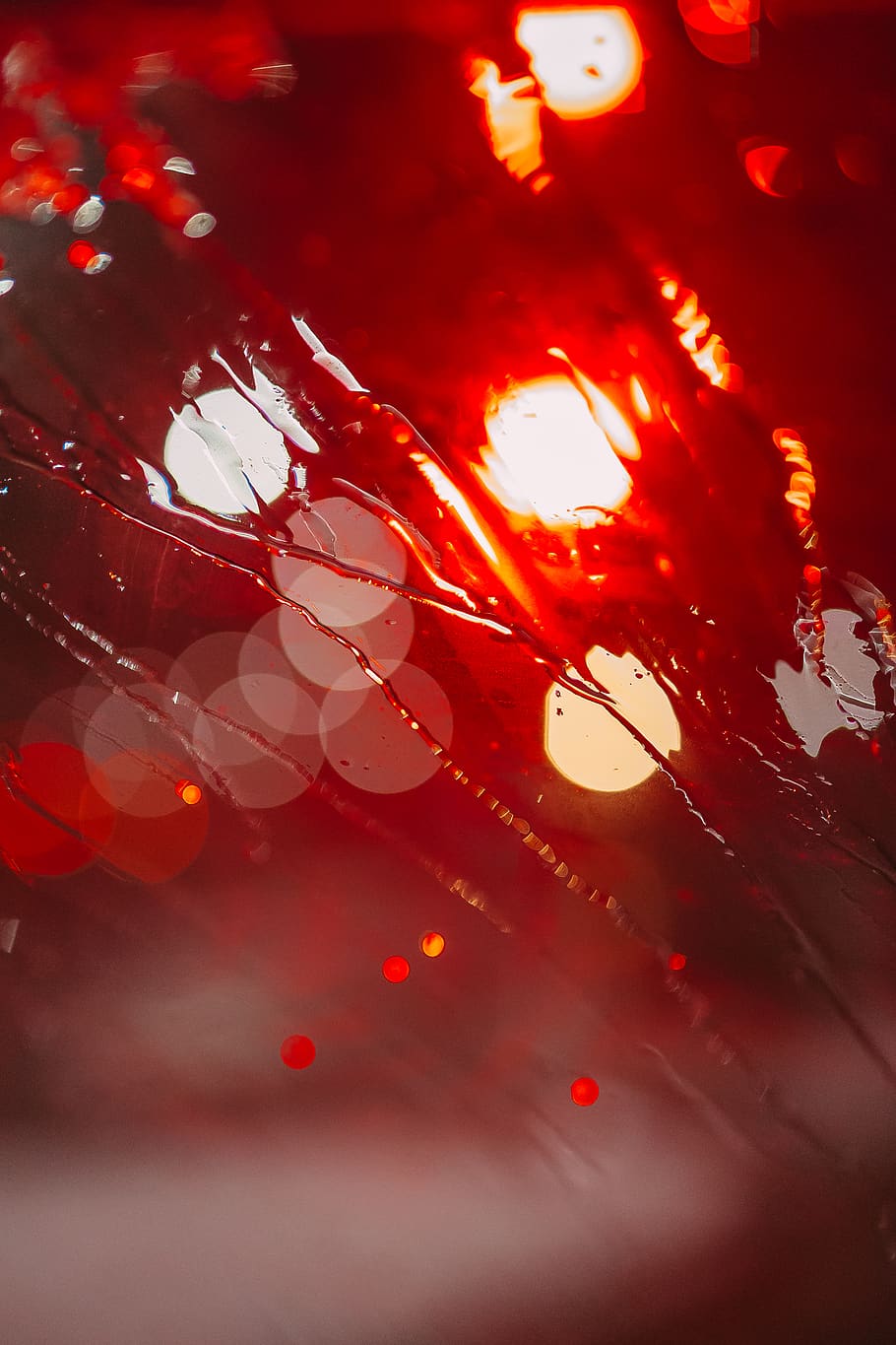 Red traffic lights seen through a rain-soaked windshield - Light red