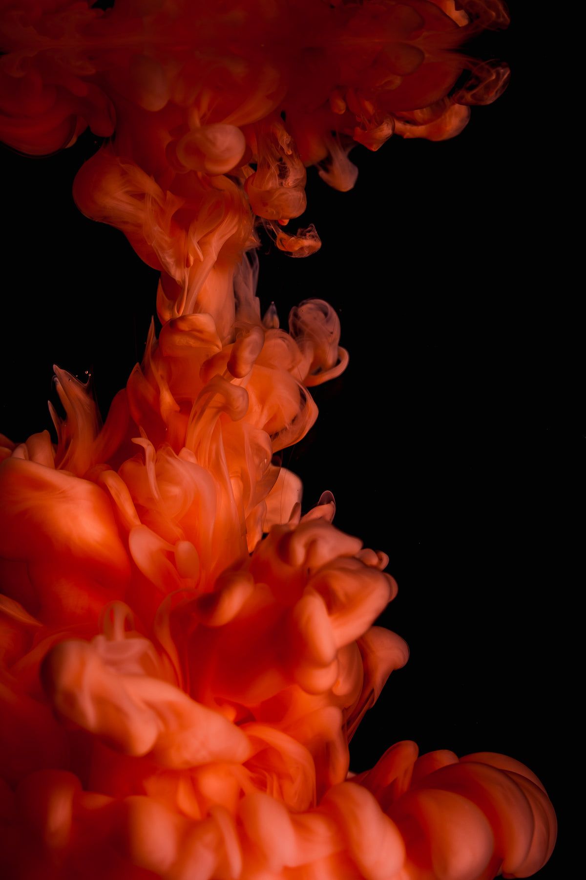 An abstract image of orange ink in water - Dark orange, magic