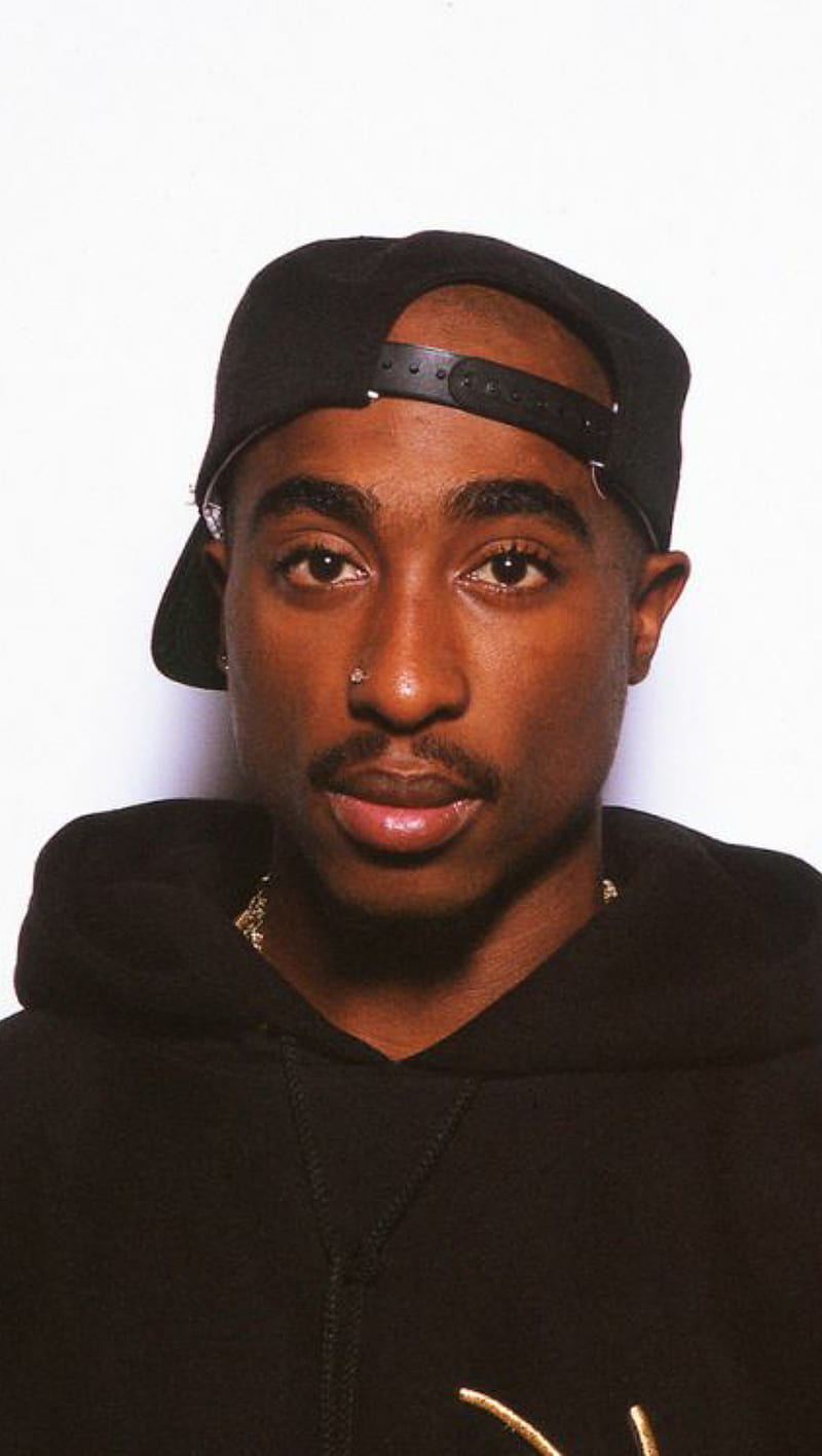 A man wearing black clothing and hat - Tupac