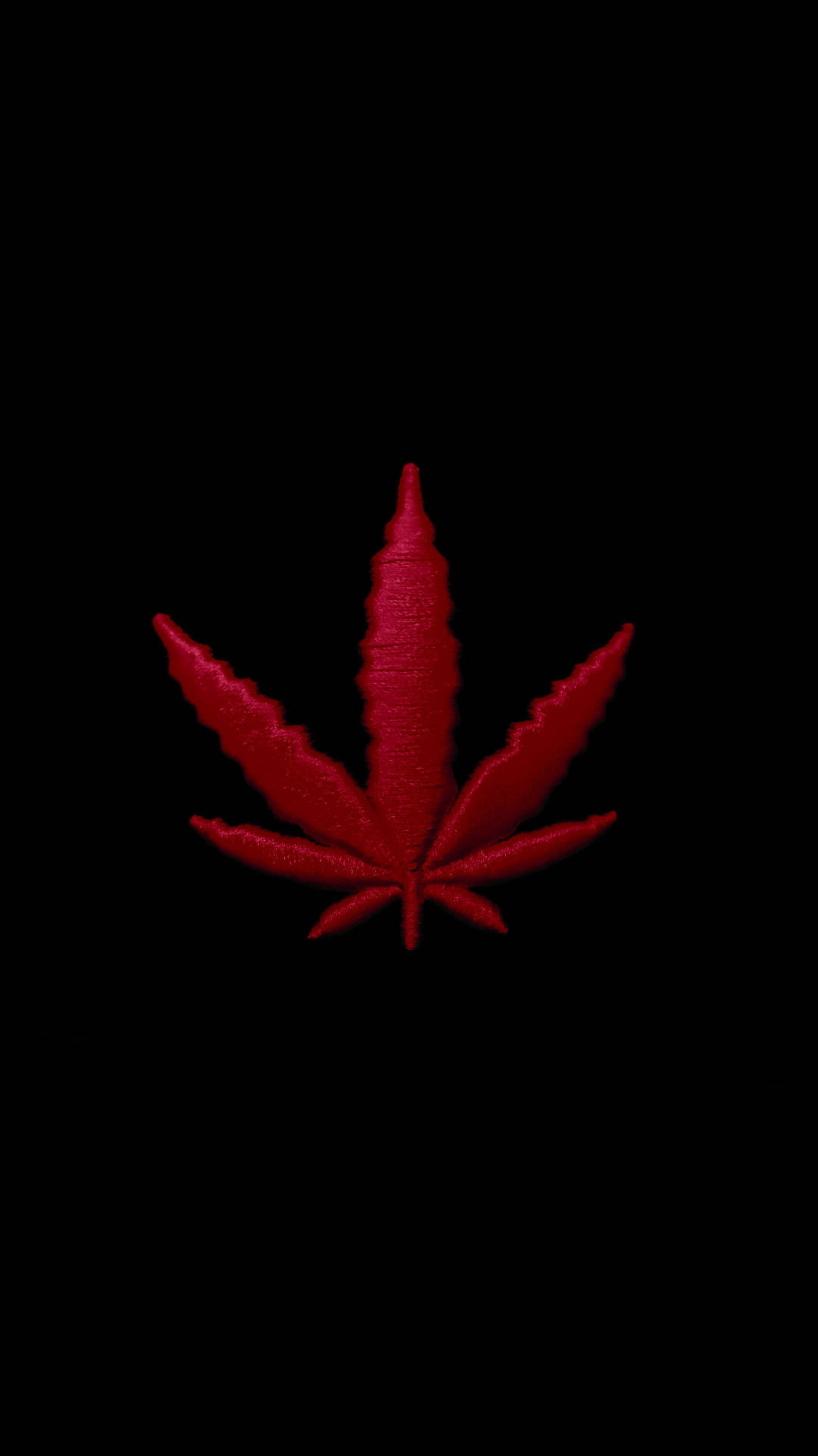 A red cannabis leaf on a black background - Weed