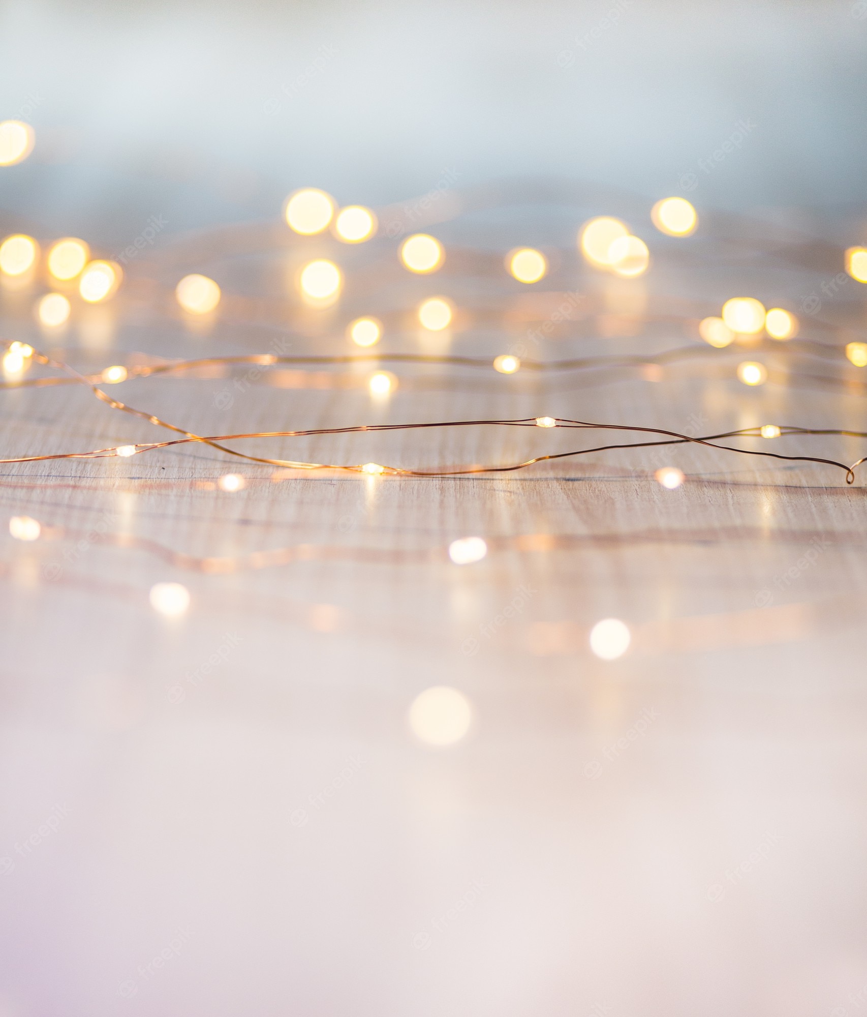 A string of fairy lights on a wooden floor - Blurry