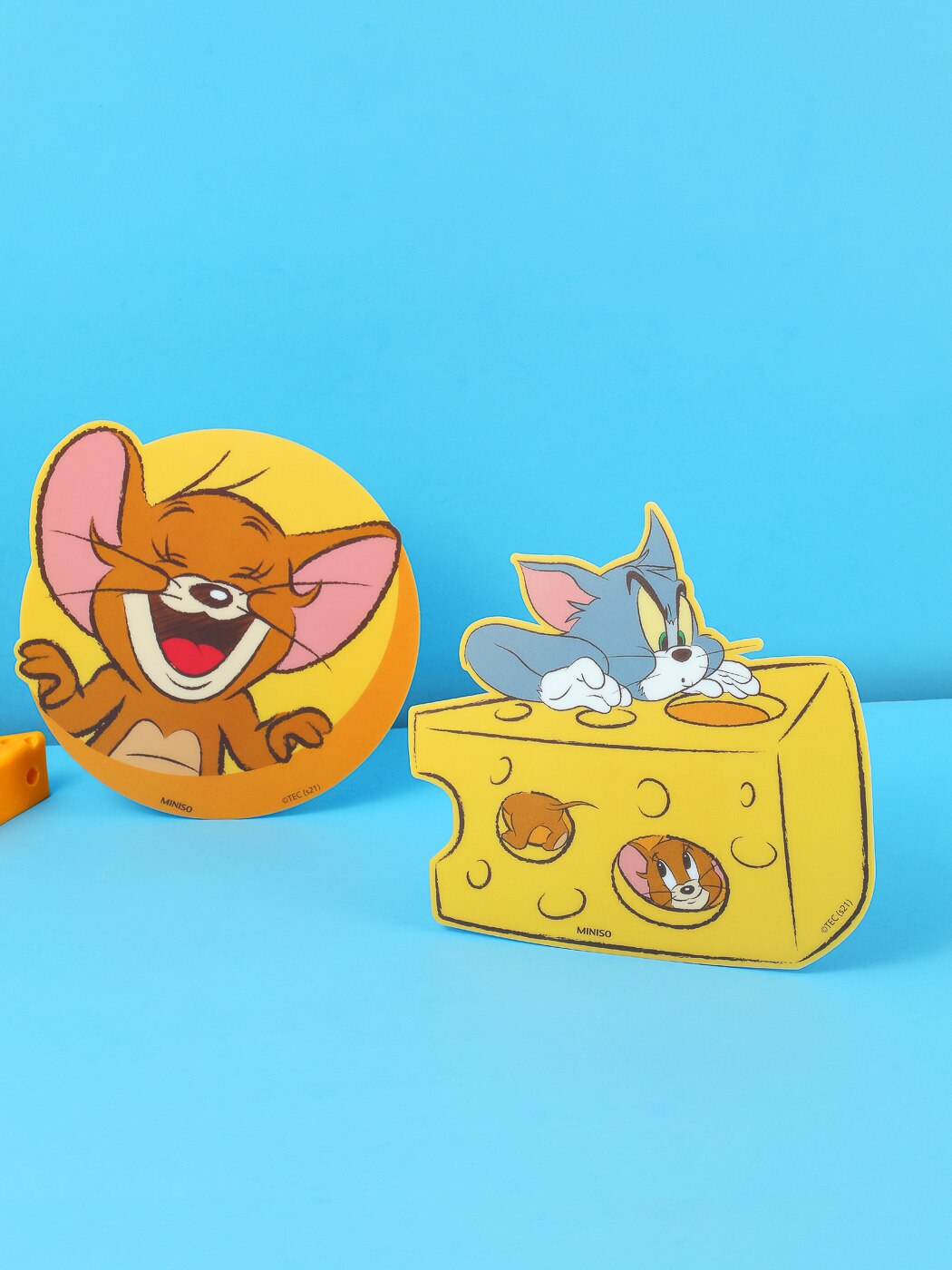A cheese slice and two cartoon characters - Tom and Jerry