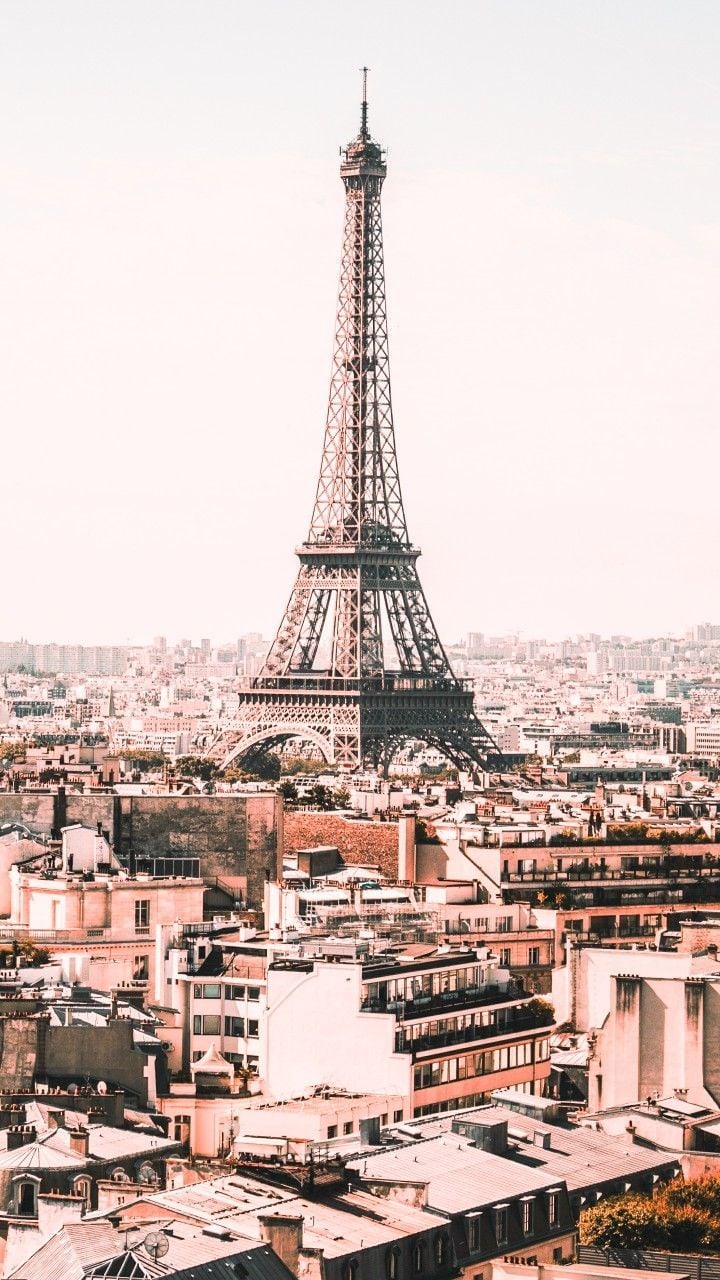 The eiffel tower is seen in a city - Paris