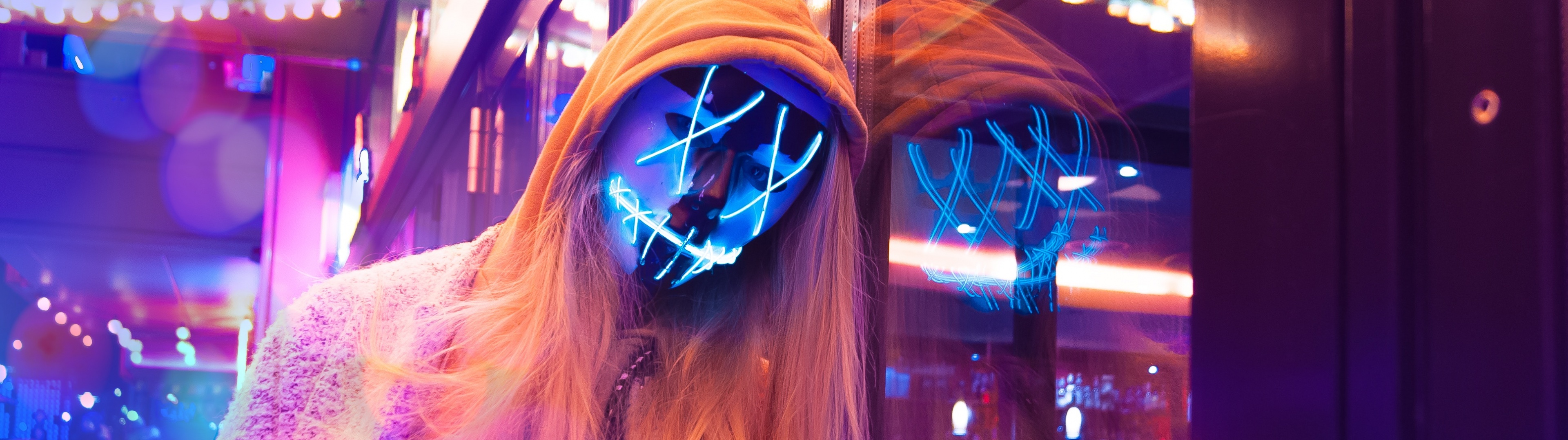 A woman with blonde hair and blue lighting - Neon pink