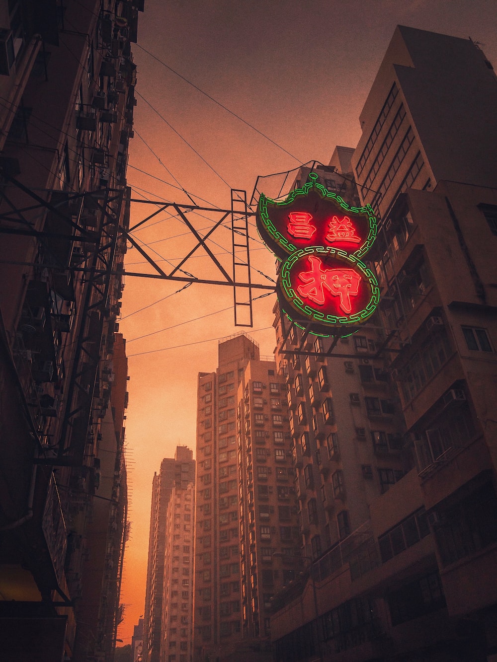 A neon sign for a Chinese restaurant in a city - Neon orange