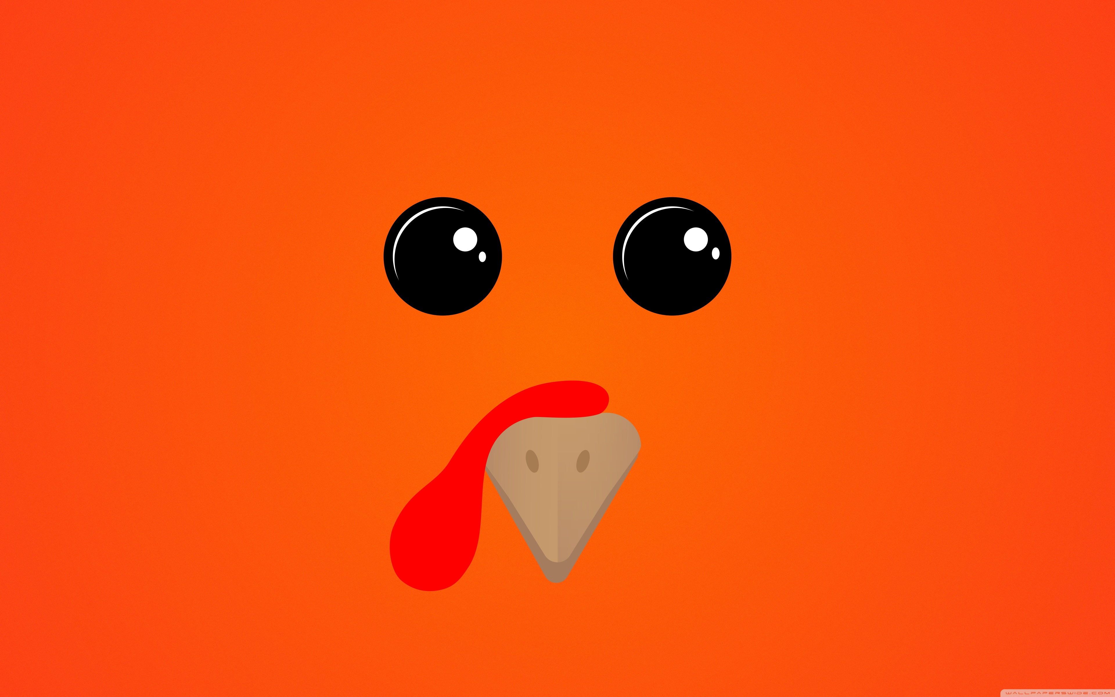 A close up of an orange chicken with black eyes - Funny