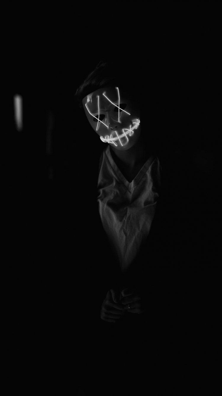 A person wearing a mask with light on it - Black, dark
