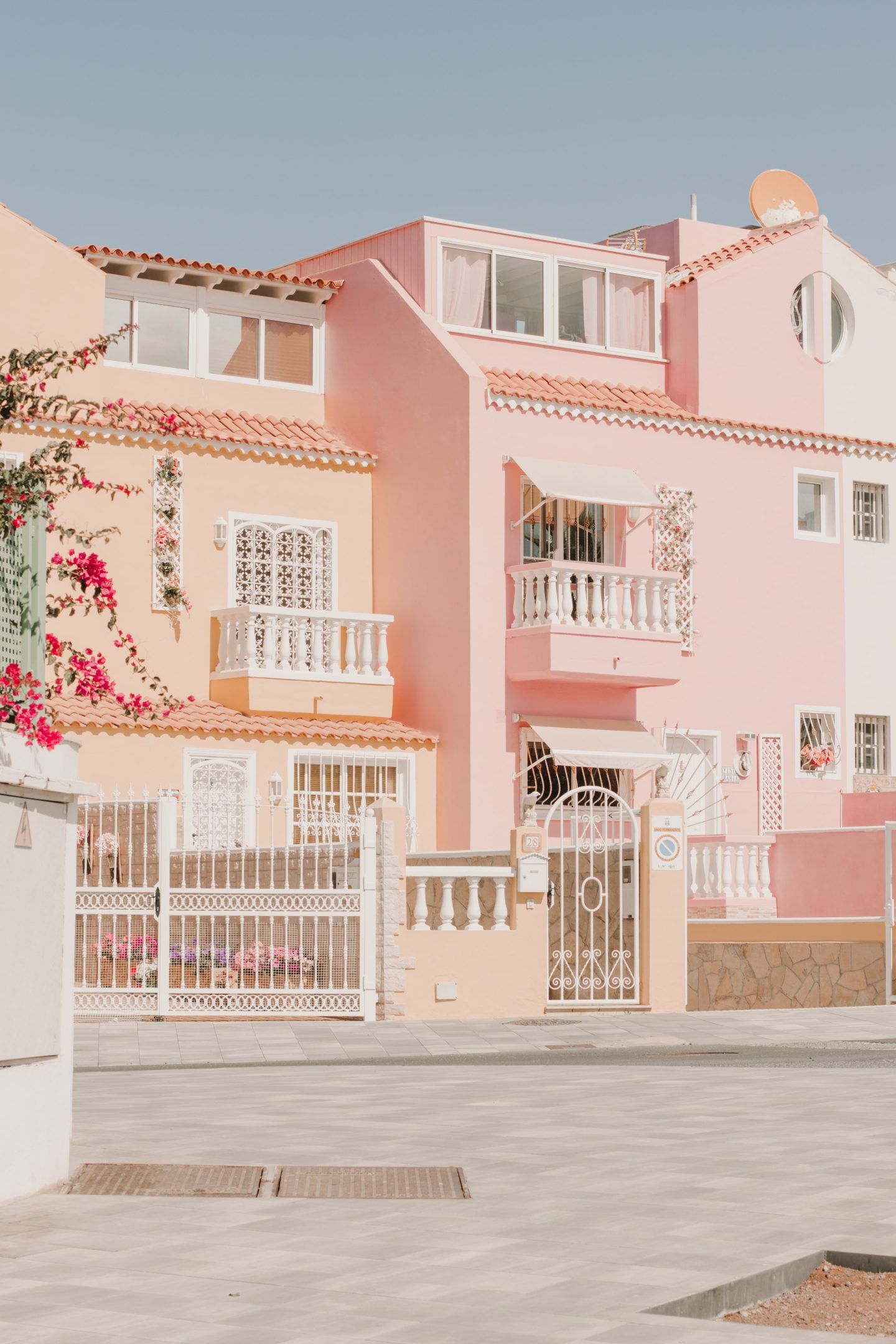 A row of pink houses with white fences and railings. - Cute pink, architecture