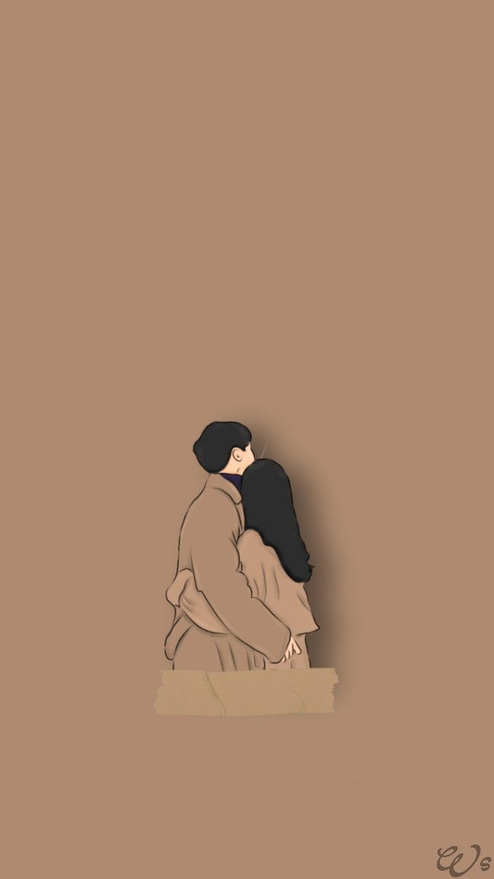 A couple is hugging each other in front of some brown wall - Couple
