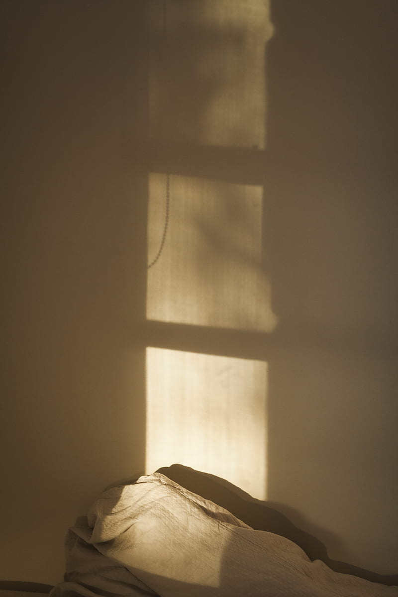 A bed with the sun shining on it - Shadow