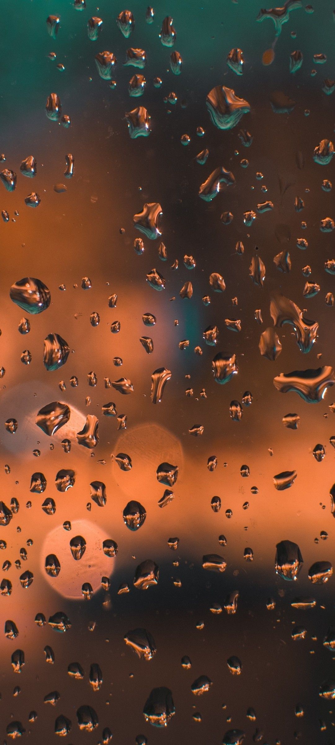 A close up of rain drops on the window - 1080x2400