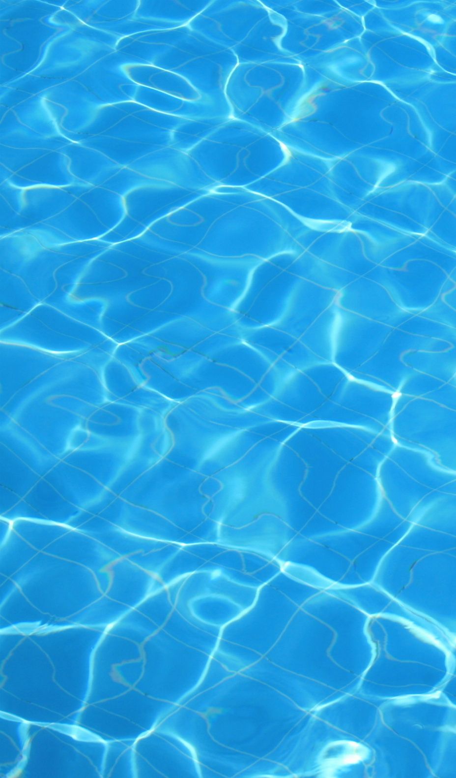 Blue water in a pool with light reflecting on it - Swimming pool