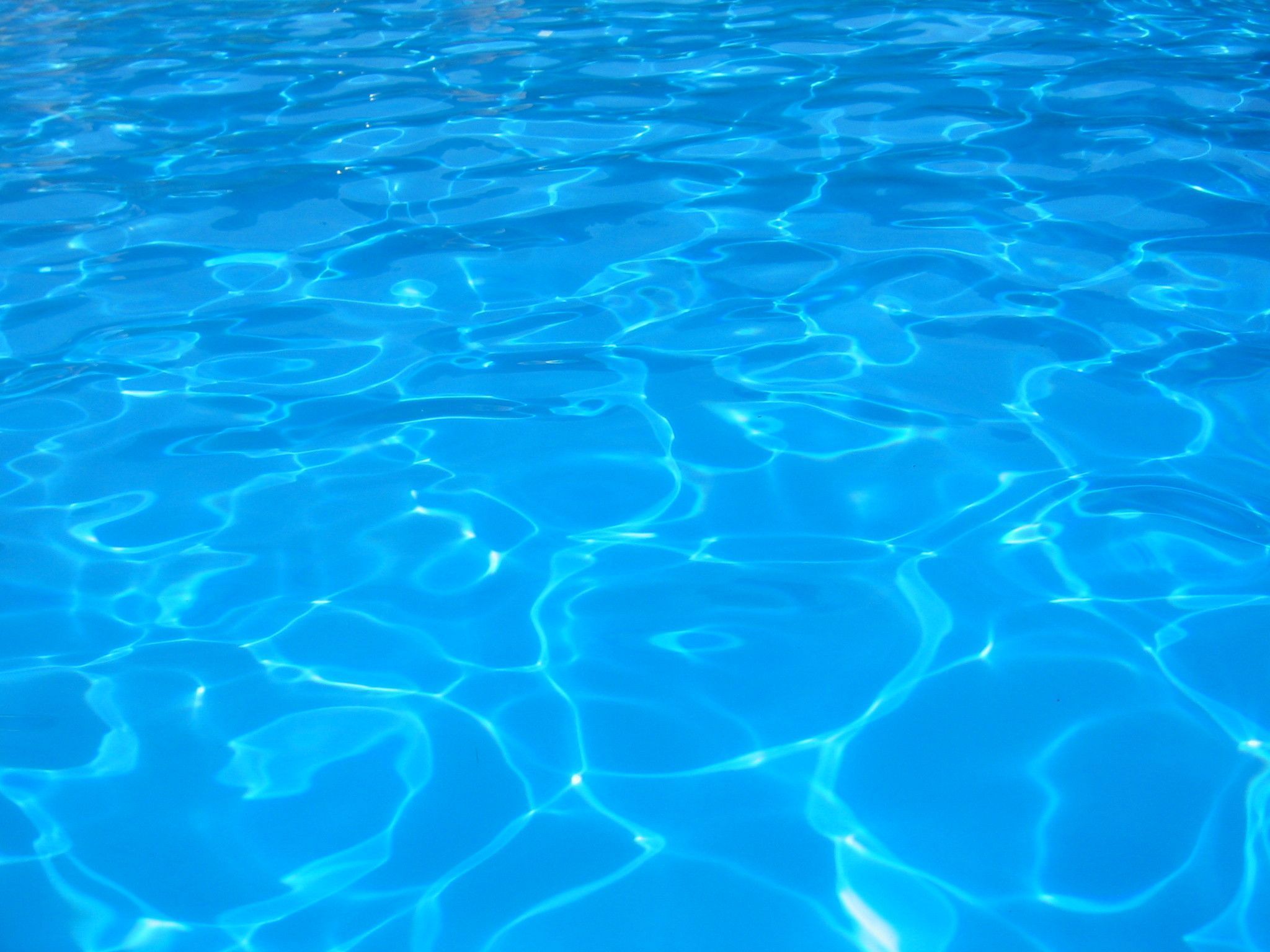 The water in the pool is blue and clear. - Swimming pool