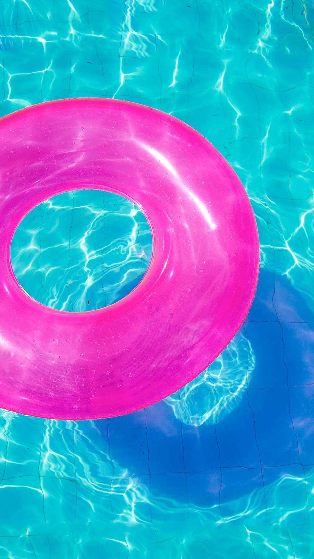 A pink float in the middle of blue water - Swimming pool