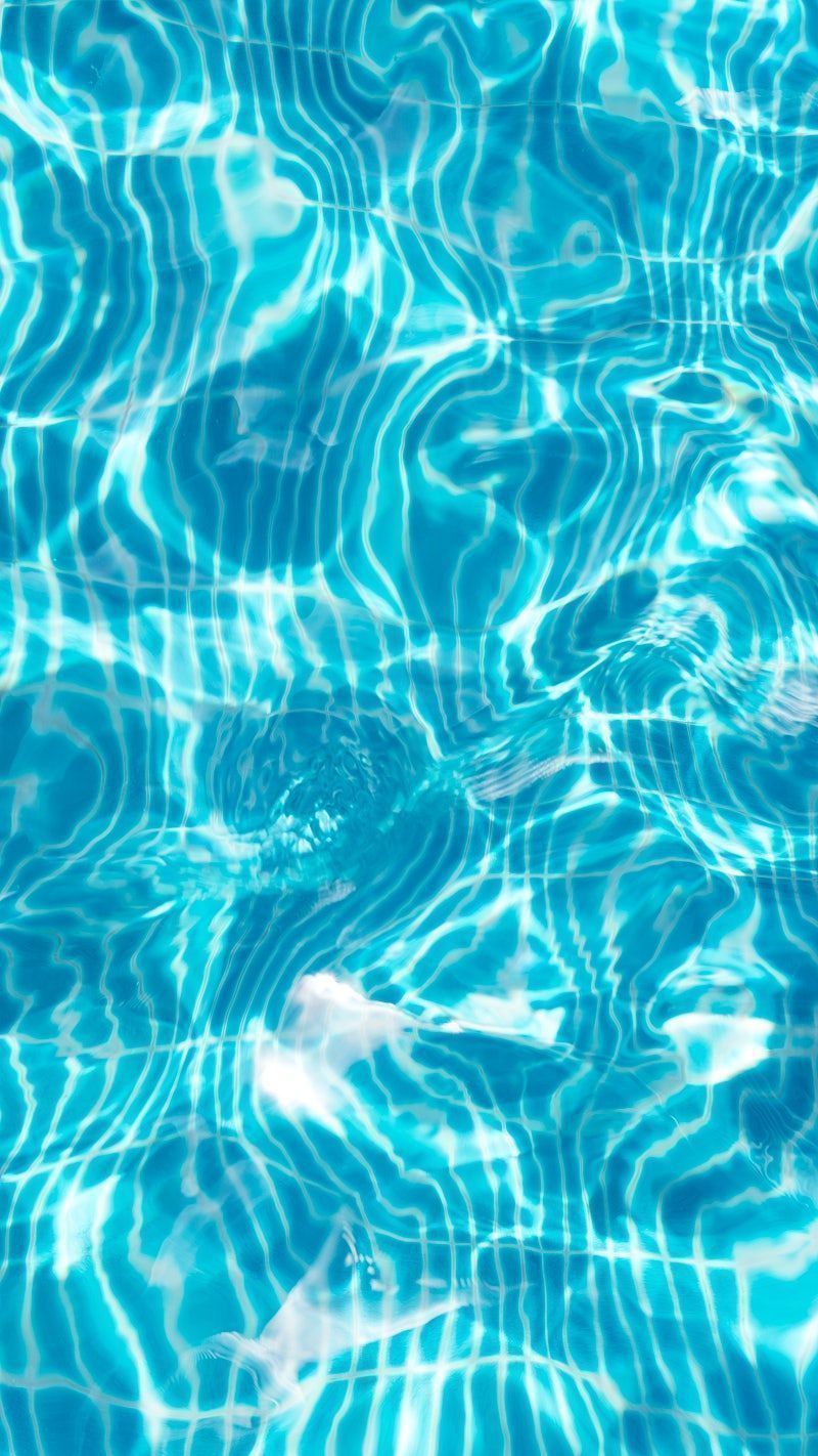 A close up of a pool with light reflecting off the water - Swimming pool