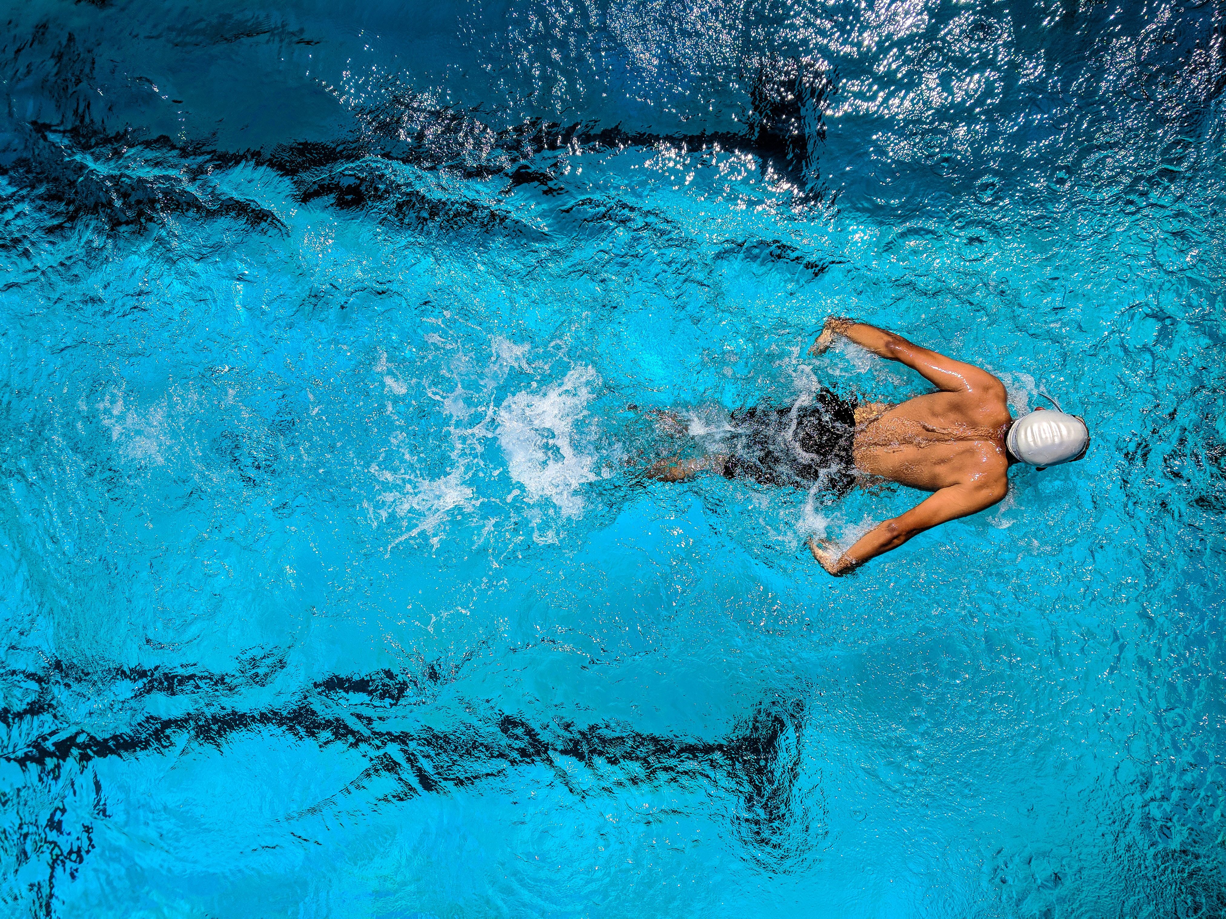 A man swimming in a pool, seen from above - Swimming pool