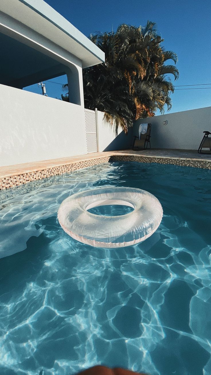 A person floating in the pool with an inflatable ring - Swimming pool