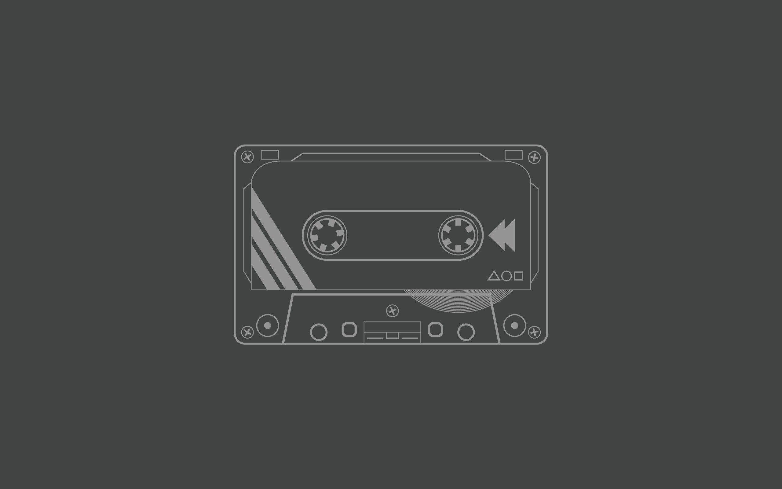 A cassette tape icon on gray background - Technology
