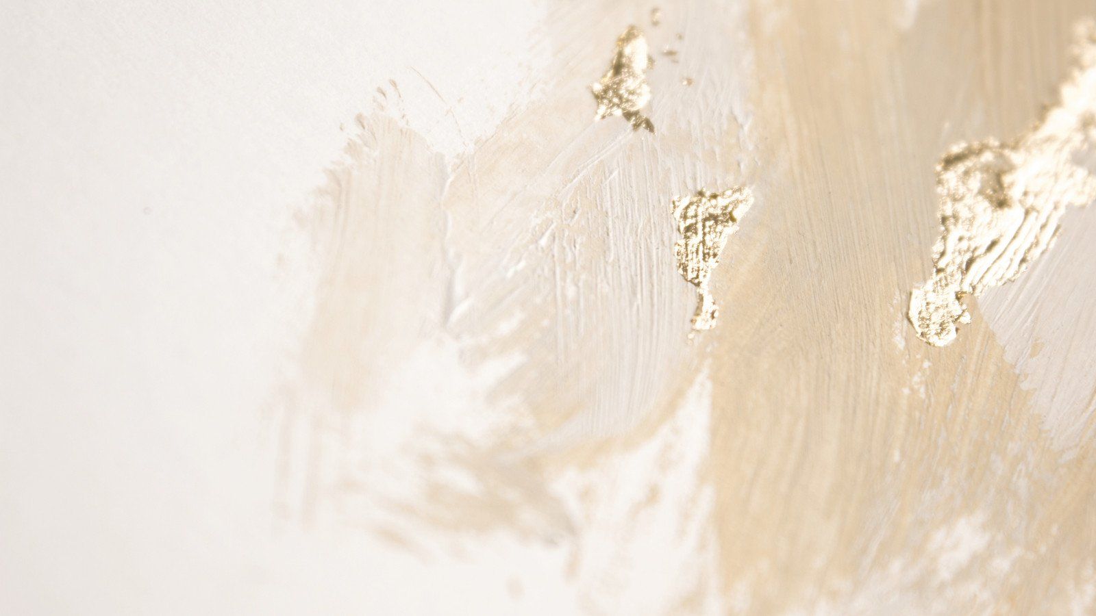 Close up of a white wall with gold paint strokes - Neutral