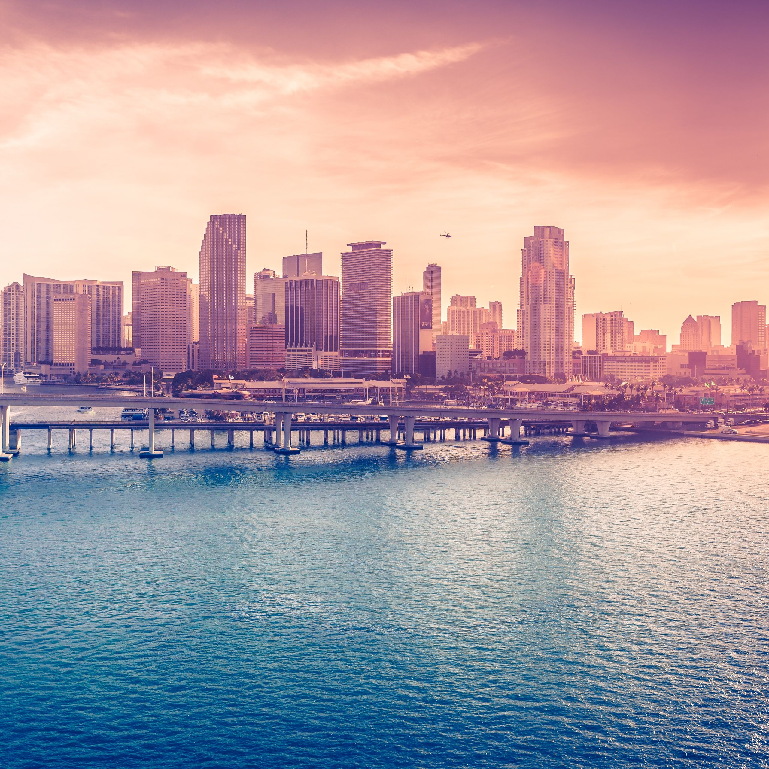 A city skyline with a body of water in front of it - Miami