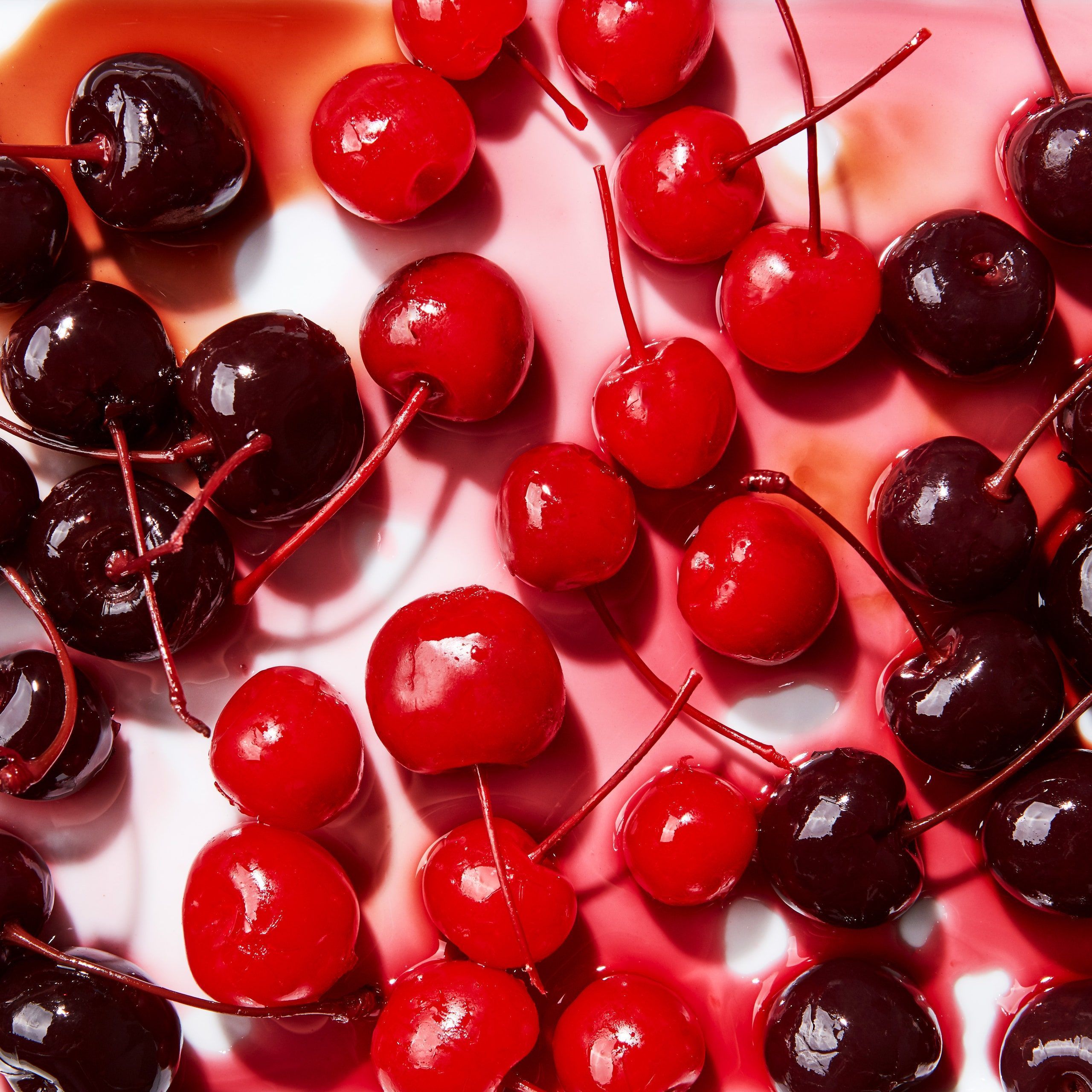 A plate of cherries with some red juice - Cherry