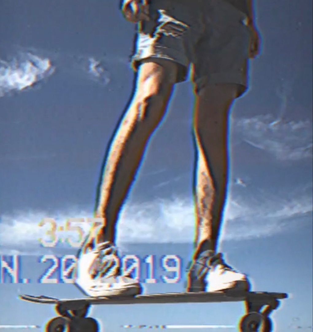 A person standing on a skateboard with the date 2019 - Skater